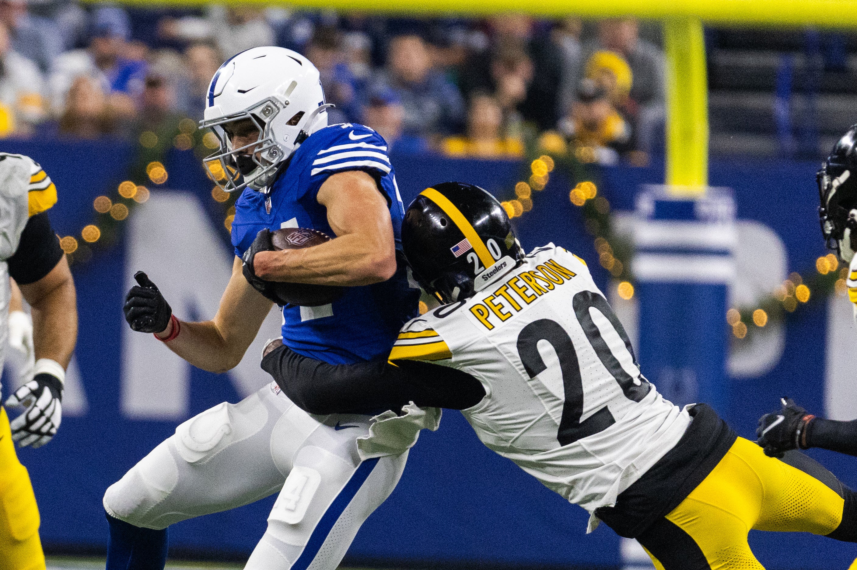 Dec 16, 2023; Indianapolis, Indiana, USA; Indianapolis Colts wide receiver Alec Pierce (14) catches the ball while Pittsburgh Steelers cornerback Patrick Peterson (20) defends in the first half at Lucas Oil Stadium.