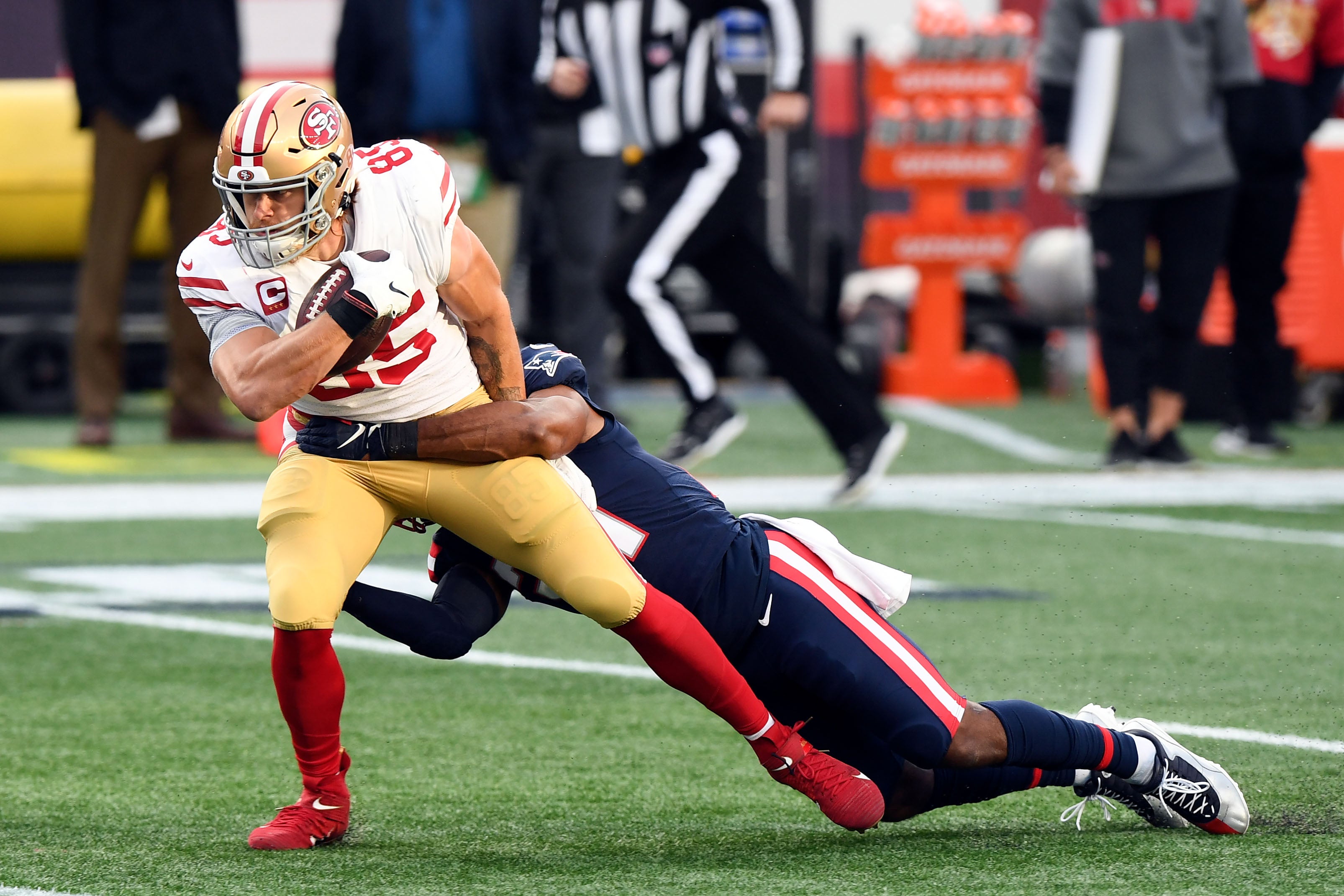 San Francisco 49ers tight end George Kittle (85) is tackled by New England Patriots strong safety Adrian Phillips (21) during the first half at Gillette Stadium.