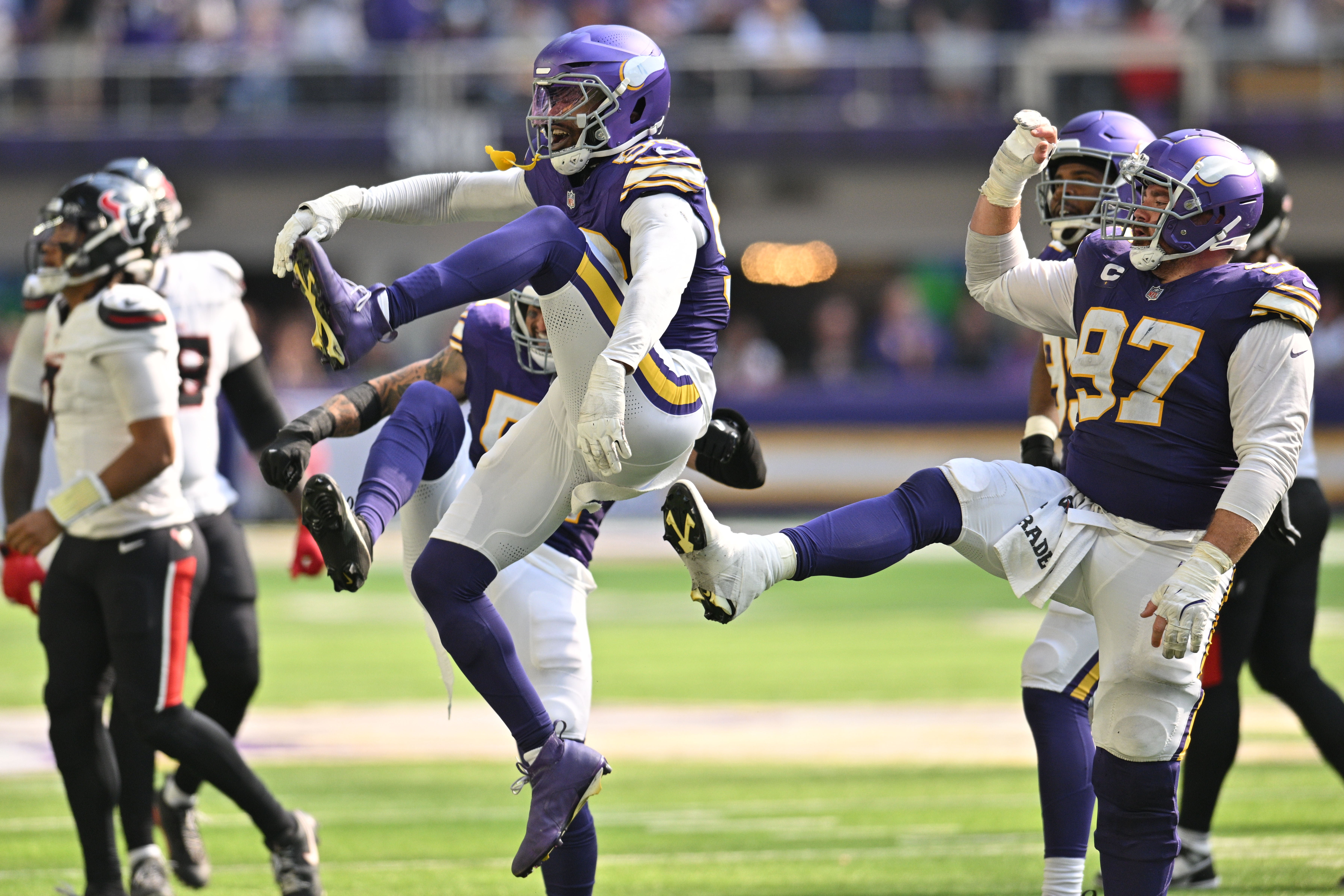 Sep 22, 2024; Minneapolis, Minnesota, USA; Minnesota Vikings linebacker Jonathan Greenard (58) and defensive tackle Harrison Phillips (97) react after a sack against the Houston Texans during the fourth quarter at U.S. Bank Stadium.