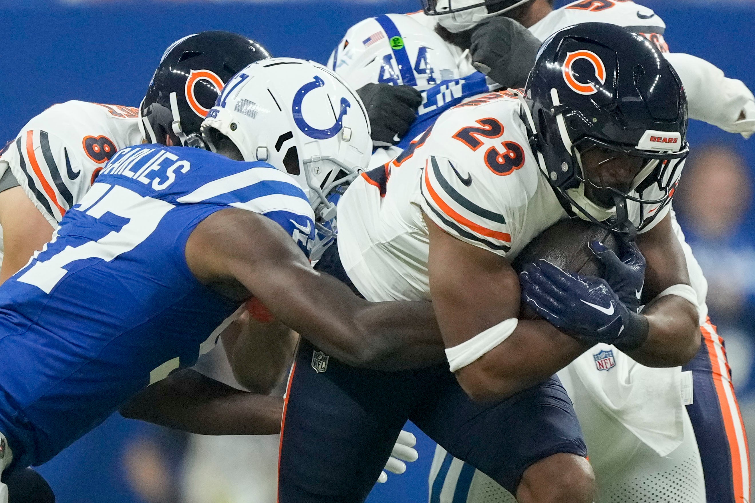 Sep 22, 2024; Indianapolis, Indiana, USA; Indianapolis Colts linebacker Jaylon Carlies (57) tackles Chicago Bears running back Roschon Johnson (23) on during a game against the Chicago Bears at Lucas Oil Stadium. Mandatory Credit: