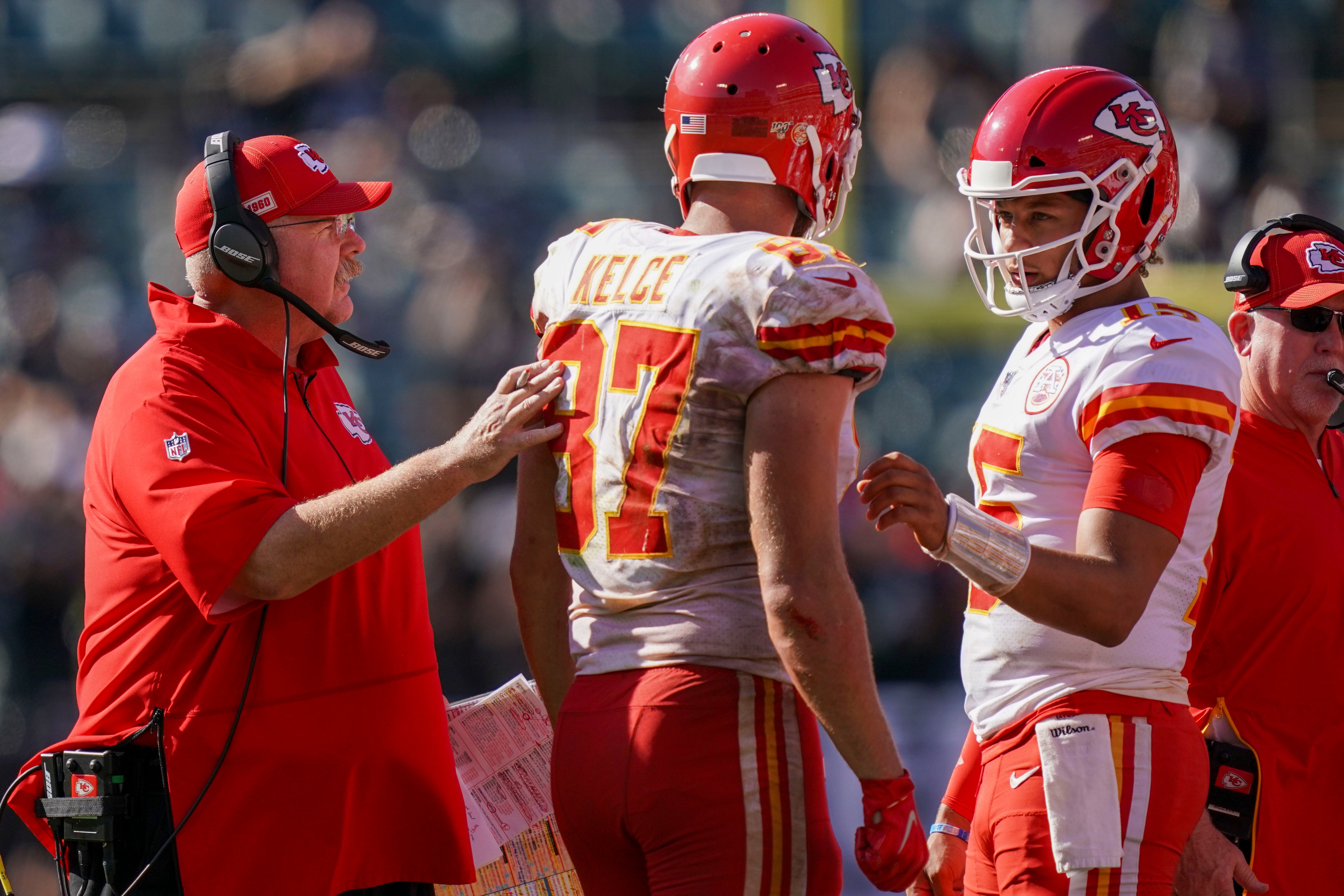 September 15, 2019; Oakland, CA, USA; Kansas City Chiefs head coach Andy Reid (right) instructs tight end Travis Kelce (87) and quarterback Patrick Mahomes (15) against the Oakland Raiders during the fourth quarter at Oakland Coliseum.