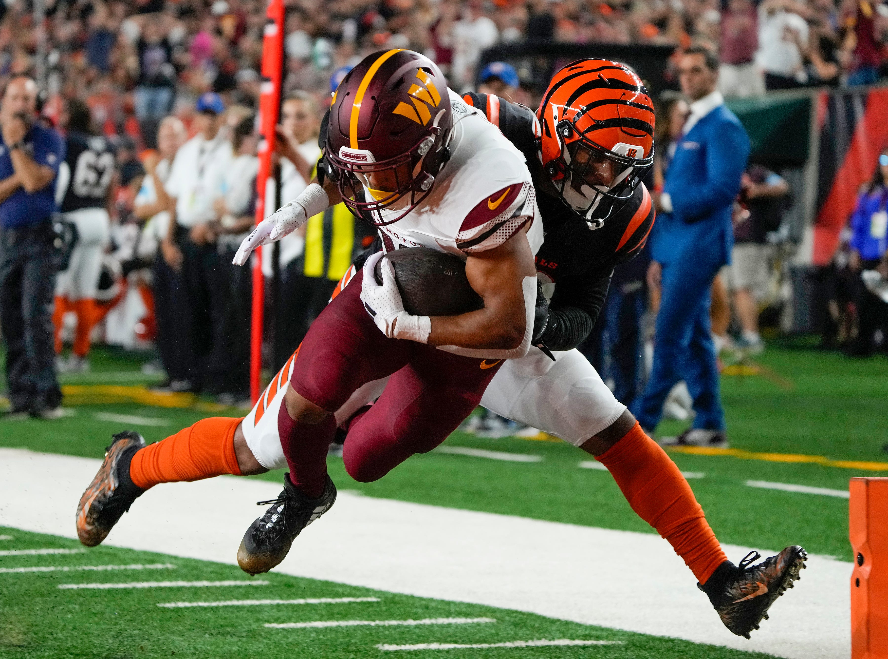 Washington Commanders running back Austin Ekeler (30) is tackled by Cincinnati Bengals safety Geno Stone (22) in the 2nd quarter during Monday Night Football on September 23, 2024 at Paycor Stadium. The Bengals lost 38-33.