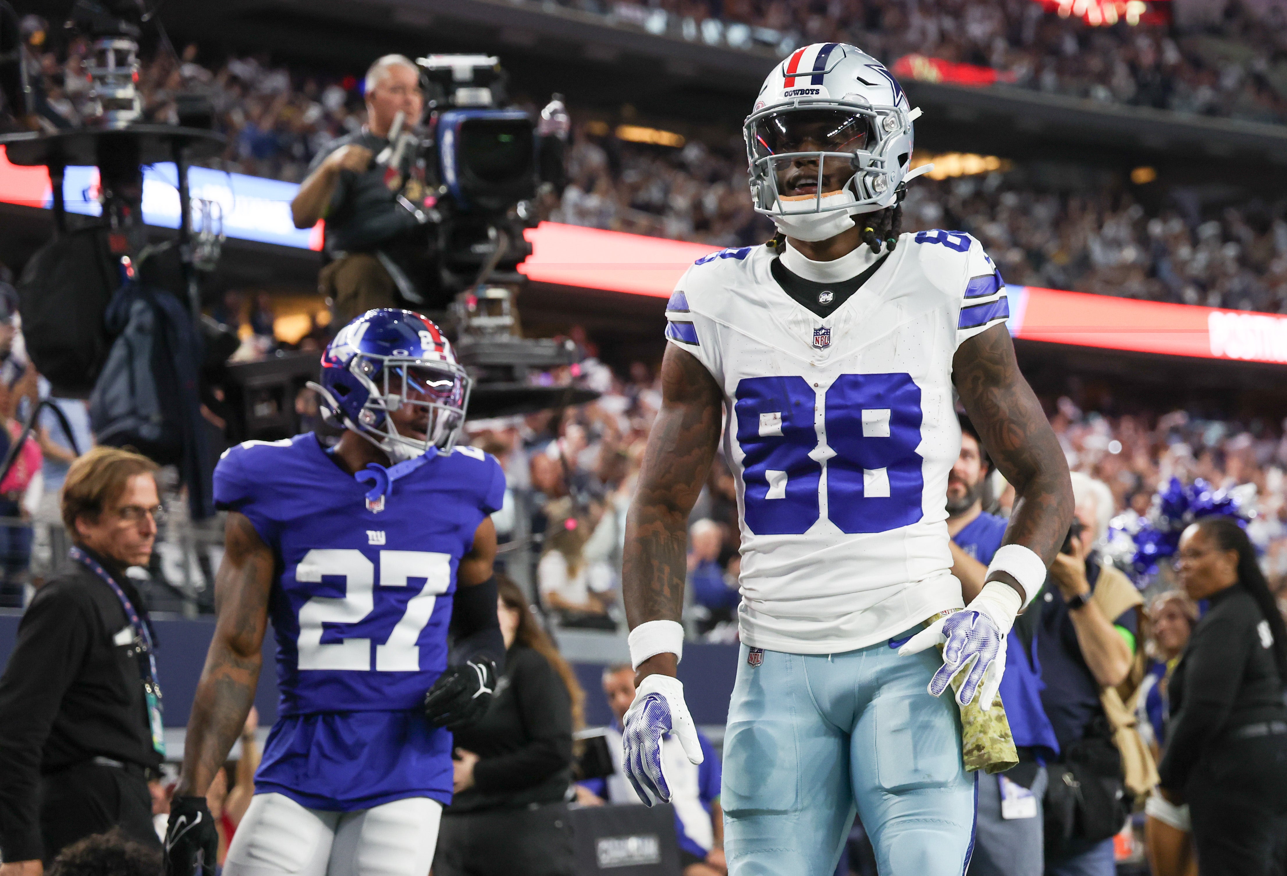 Dallas Cowboys wide receiver CeeDee Lamb (88) reacts after running past New York Giants safety Jason Pinnock (27) and scoring a touchdown during the first quarter at AT&T Stadium.
