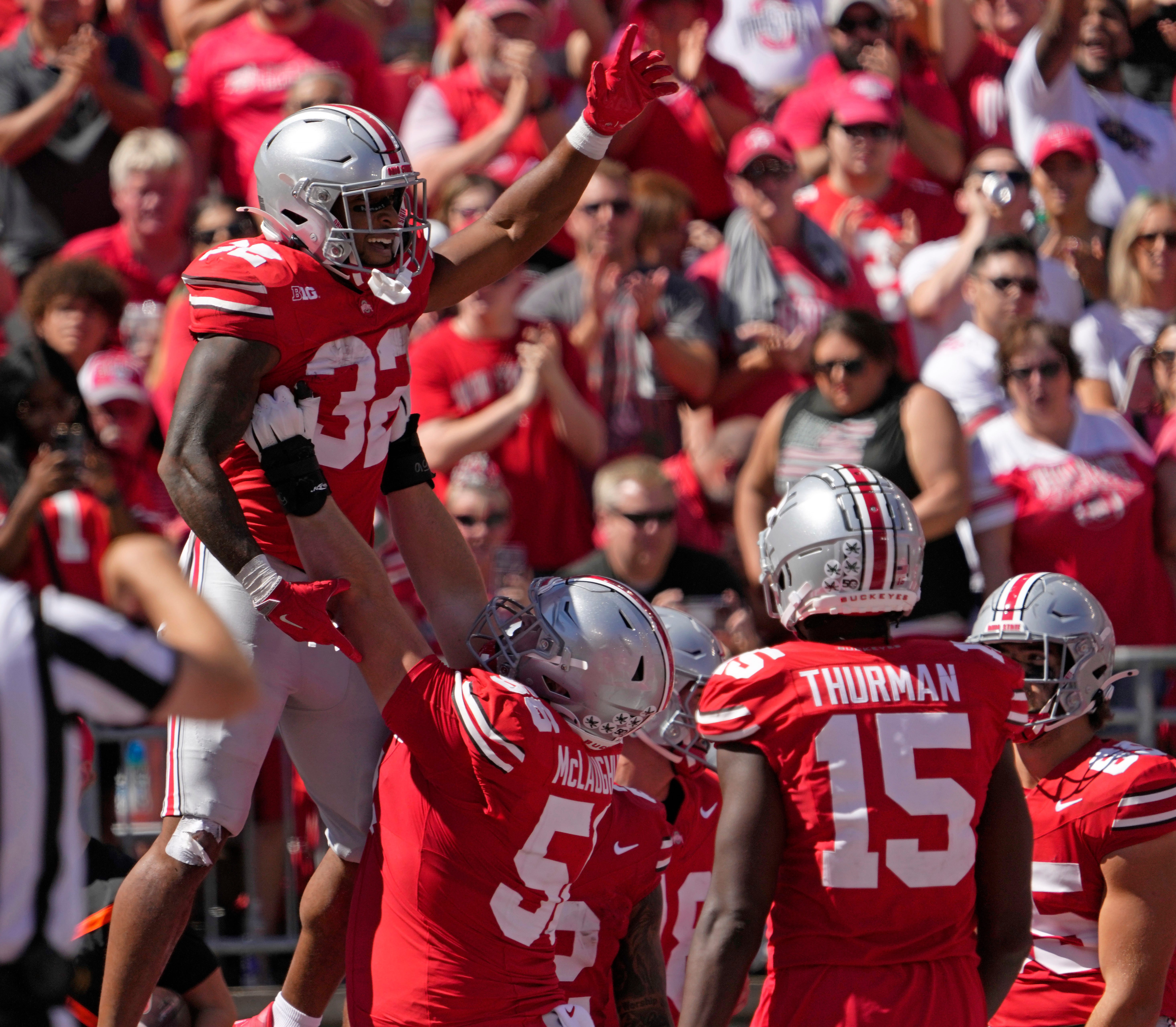 Ohio State running back TreVeyon Henderson is lifted into the air by offensive lineman Seth McLaughlin after scoring a touchdown.