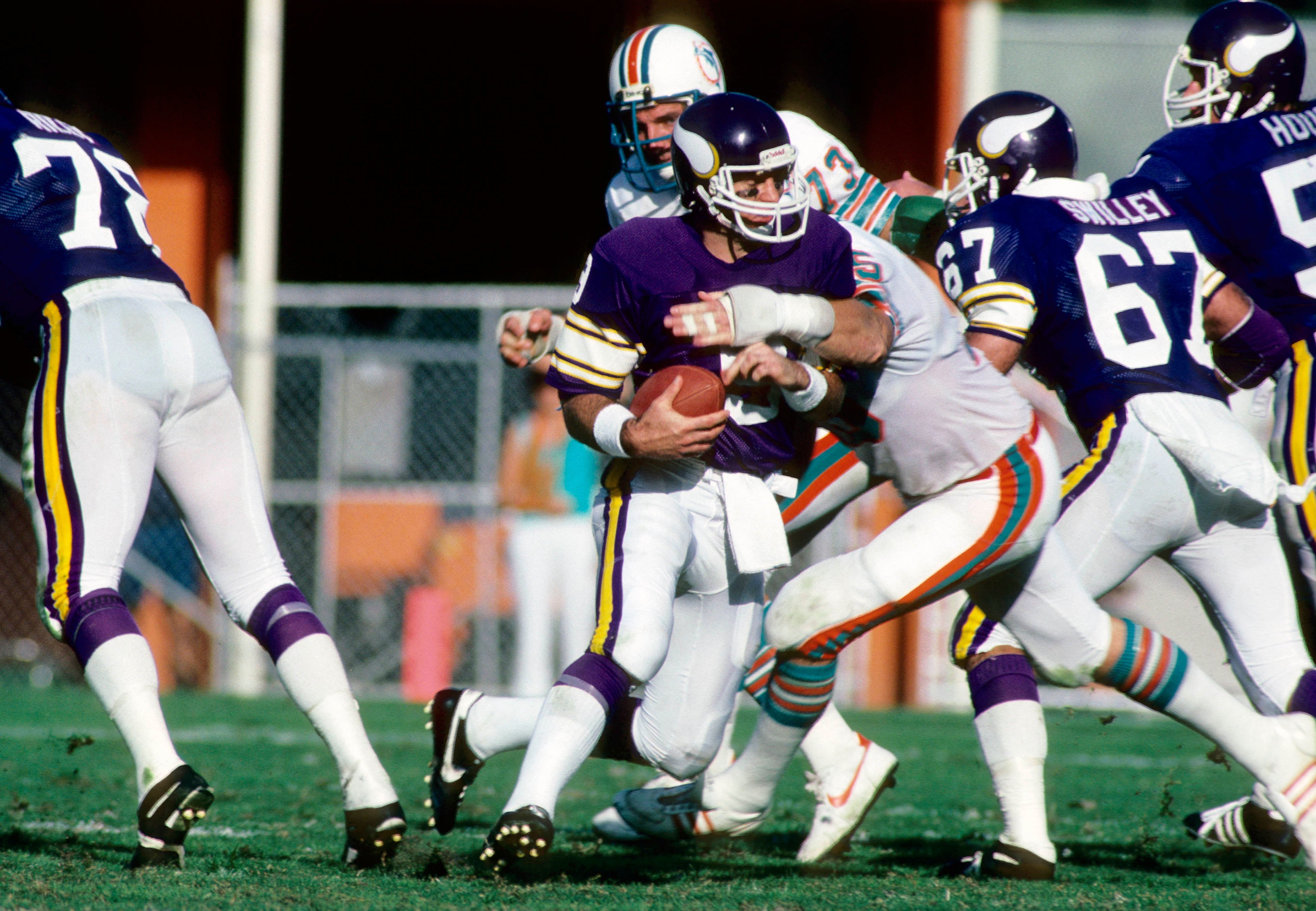 Dec 5, 1982; Miami, FL, USA; FILE PHOTO; Miami Dolphins defensive end Doug Betters (75) tackles Minnesota Vikings quarterback Tommy Kramer (9) at the Orange Bowl.