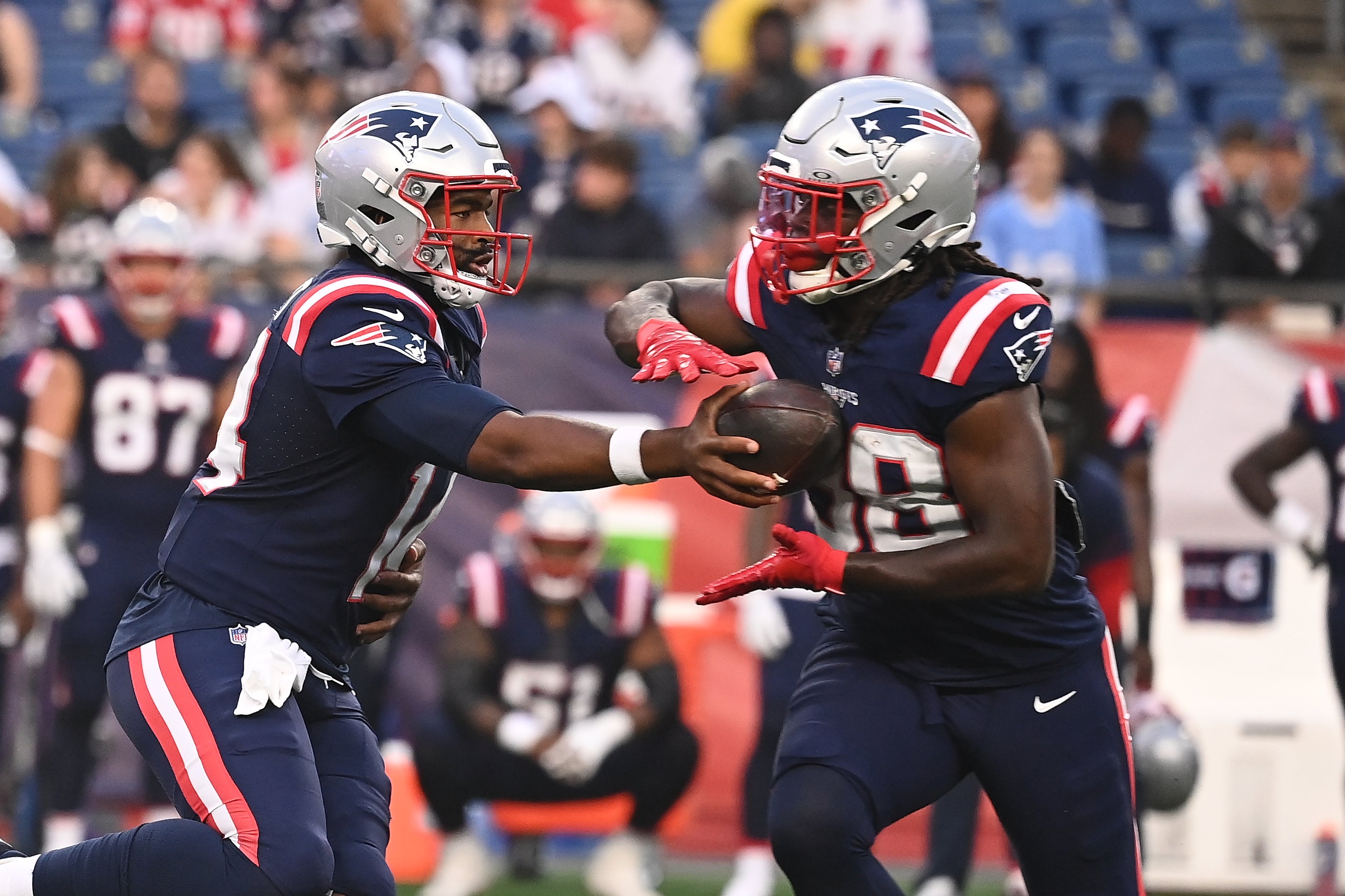 Aug 15, 2024; Foxborough, MA, USA; New England Patriots quarterback Jacoby Brissett (14) hands the ball to running back Rhamondre Stevenson (38) during the first half against the Philadelphia Eagles at Gillette Stadium.