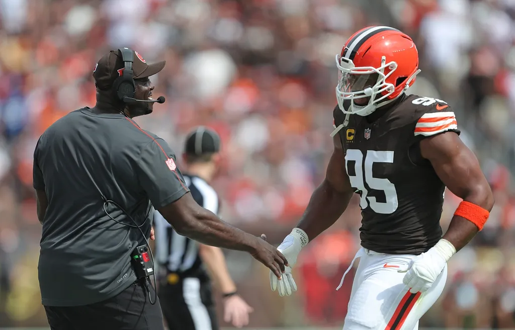 Cleveland Browns defensive line coach Jacques Cesaire, left, celebrates with defensive end Myles Garrett (95) during the first half of an NFL football game at Huntington Bank Field, Sunday, Sept. 22, 