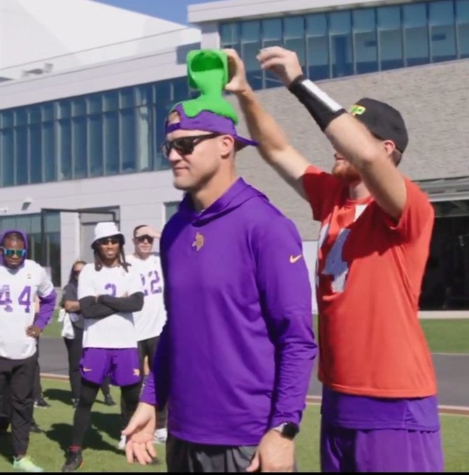 Minnesota Vikings quarterback Sam Darnold pours Nickelodeon slime over fellow quarterback J.J. McCarthy's head after winning the NVP award for his week three performance against the Houston Texans.