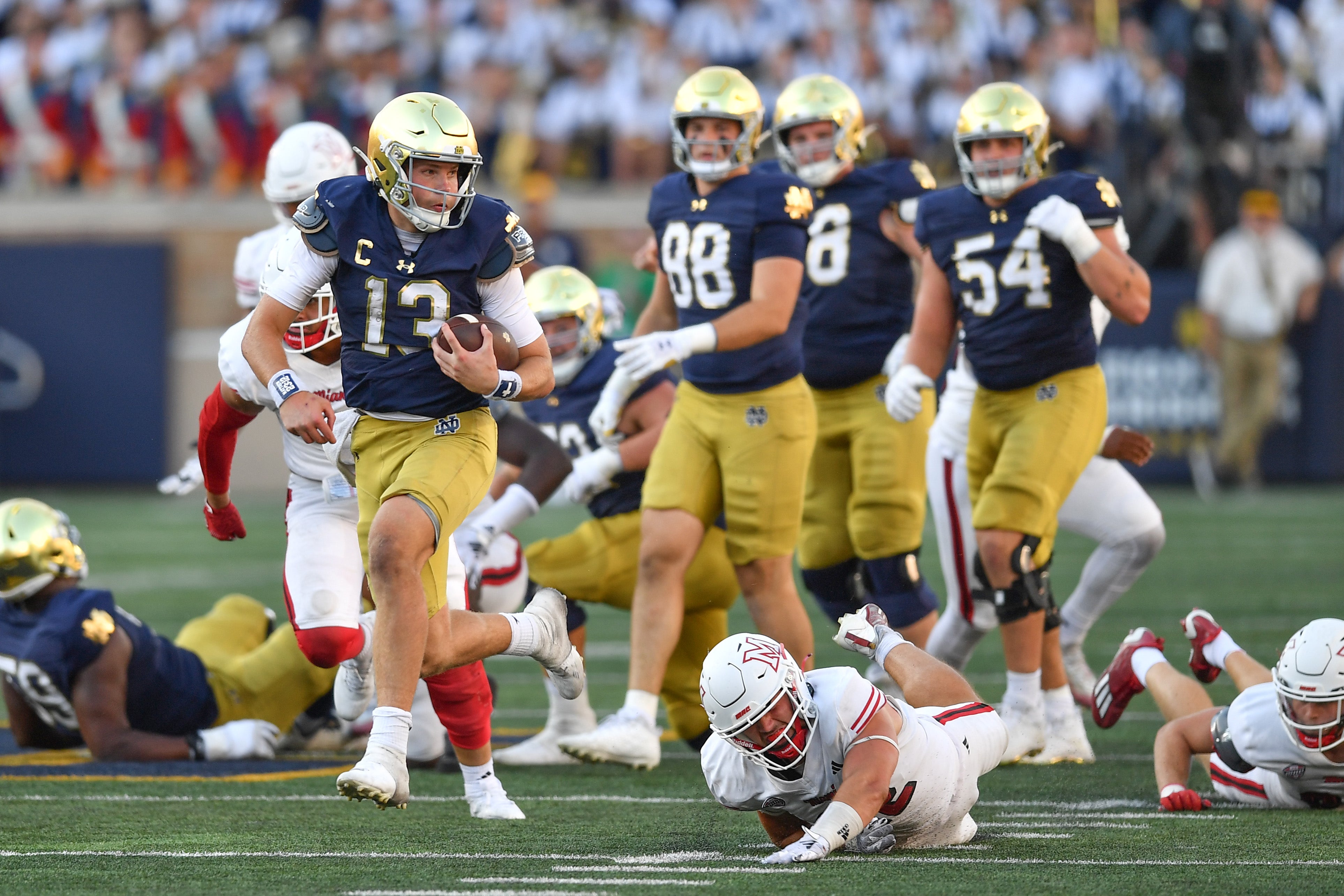 Notre Dame Fighting Irish quarterback Riley Leonard (13) runs for a touchdown in the fourth quarter against the Miami Redhawks at Notre Dame Stadium.