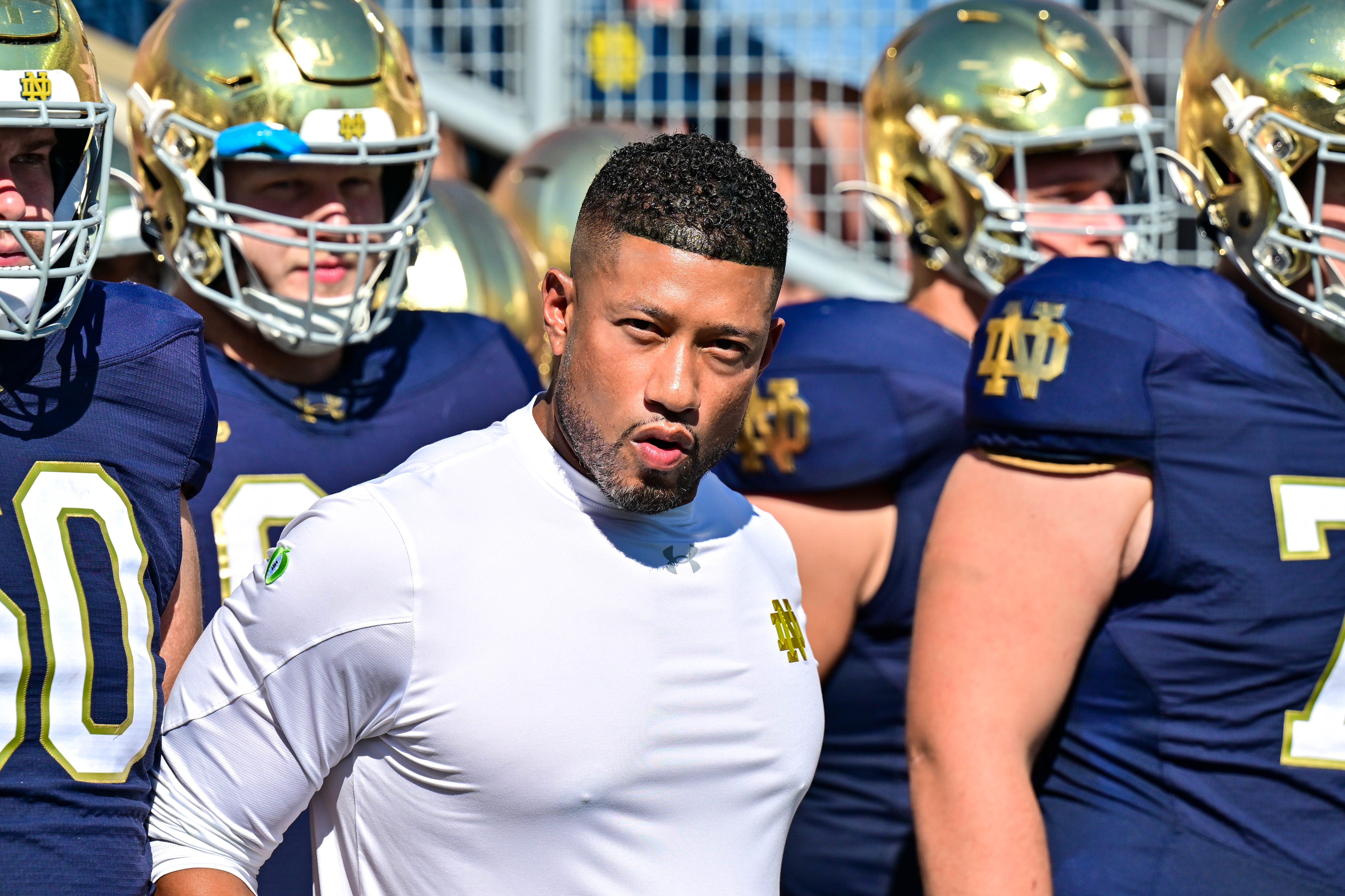 Notre Dame Fighting Irish head coach Marcus Freeman prepares to lead his players onto the field for the game against the Miami Redhawks at Notre Dame Stadium.