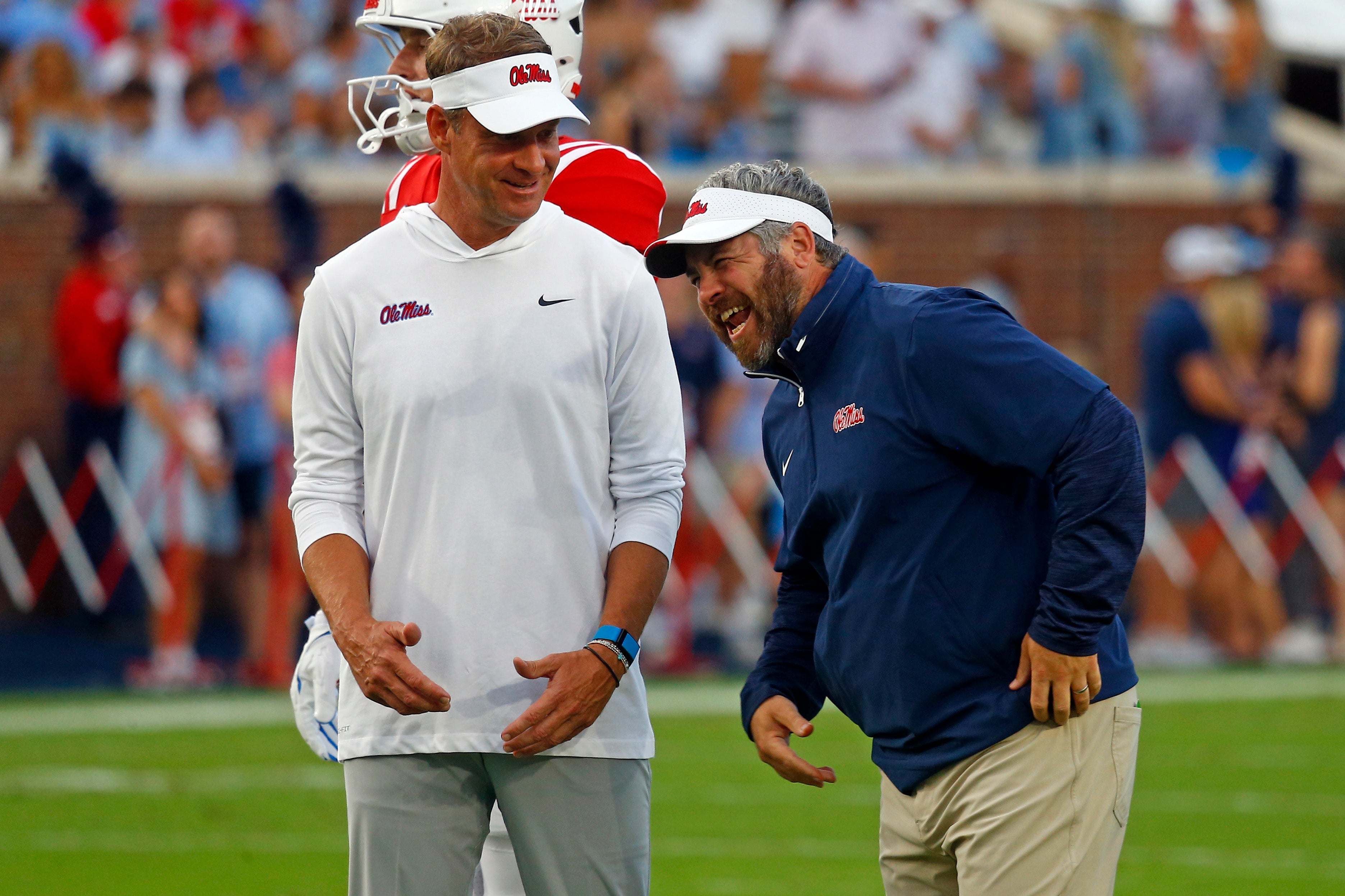Sep 21, 2024; Oxford, Mississippi, USA; Mississippi Rebels head coach Lane Kiffin (left) shares a laugh with defensive coordinator Pete Golding (right) during warm ups prior to the game against the Georgia Southern Eagles at Vaught-Hemingway Stadium.