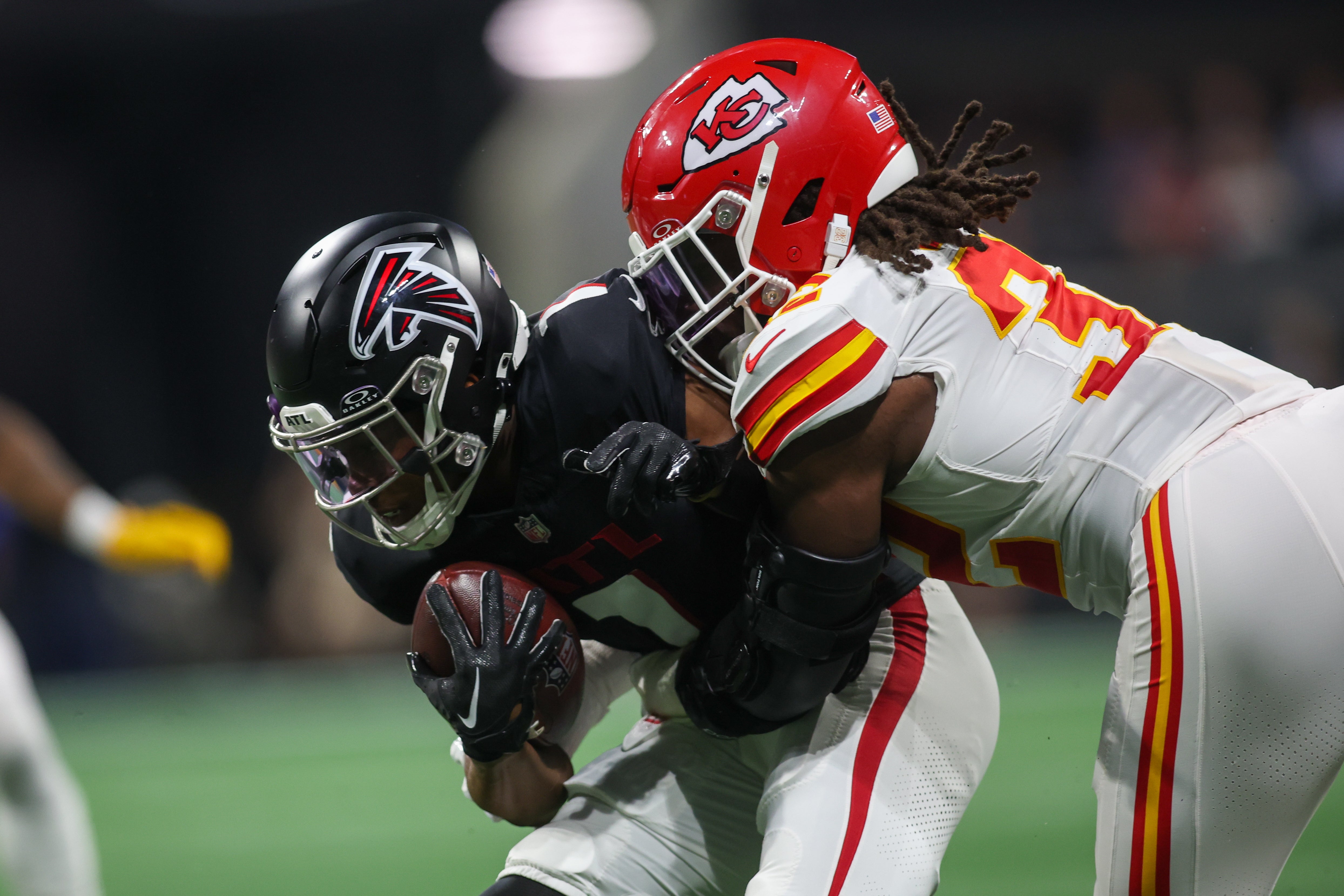 Falcons wide receiver Darnell Mooney is tackled by Chiefs linebacker Nick Bolton