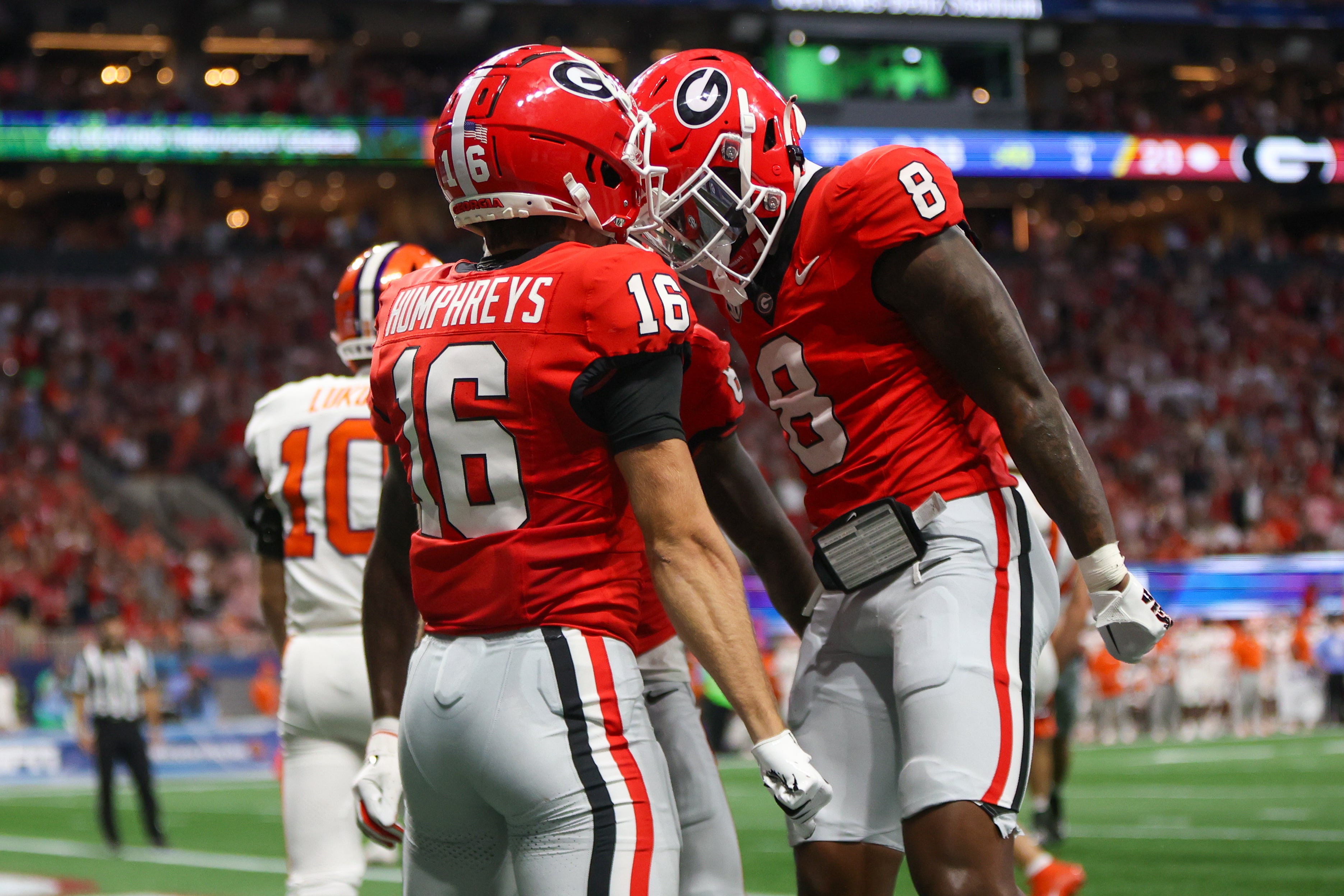 Georgia Bulldogs wide receiver London Humphreys (16) celebrates after a touchdown with wide receiver Colbie Young (8) against the Clemson Tigers in the third quarter at Mercedes-Benz Stadium.