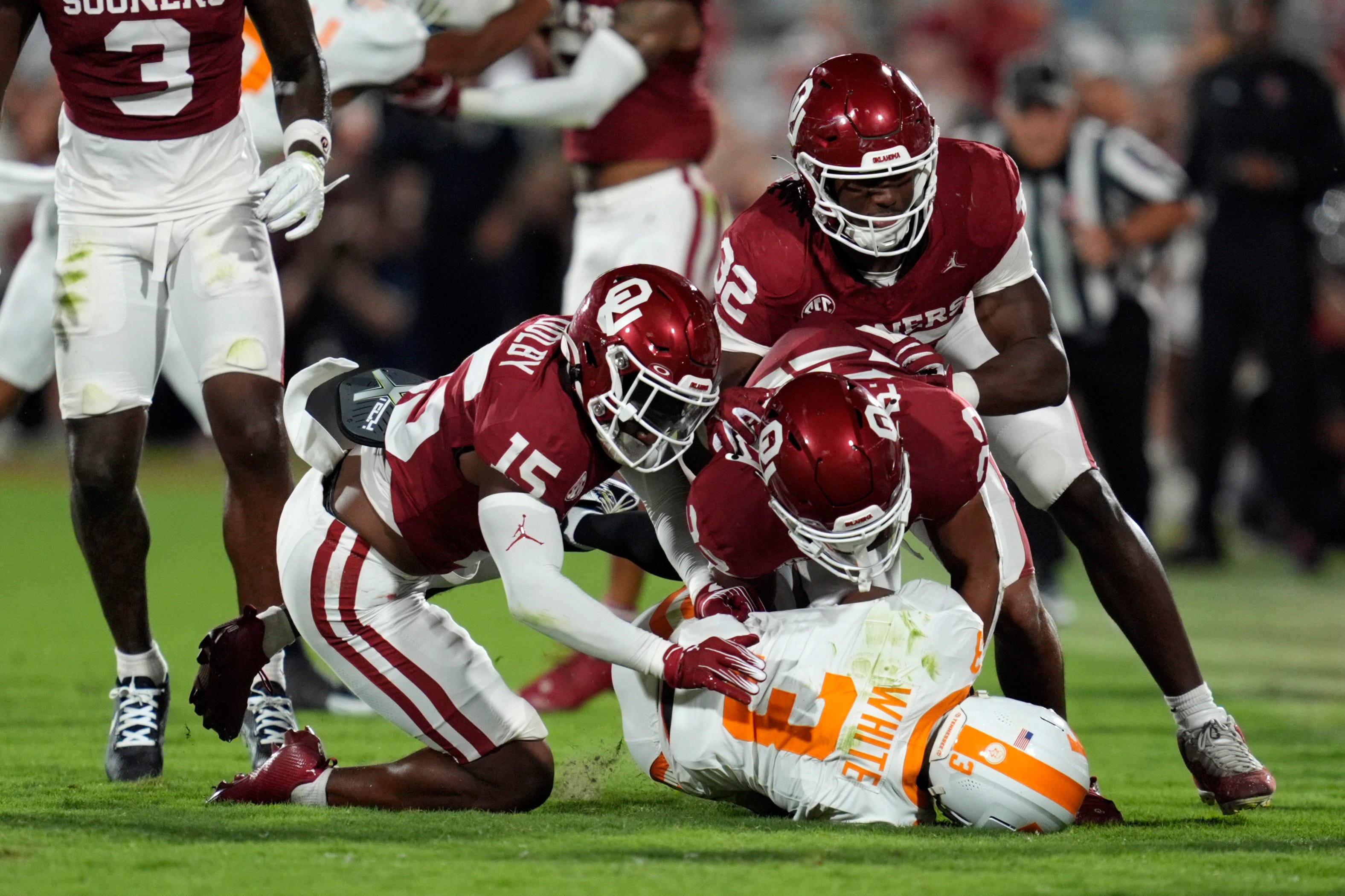 Oklahoma Sooners defensive back Kendel Dolby (15), defensive back Peyton Bowen (22) and defensive lineman R Mason Thomas (32) bring down Tennessee Volunteers wide receiver Squirrel White (3) during a college football game between the University of Oklahoma Sooners (OU) and the Tennessee Volunteers at Gaylord Family - Oklahoma Memorial Stadium in Norman, Okla., Saturday, Sept. 21, 2024.