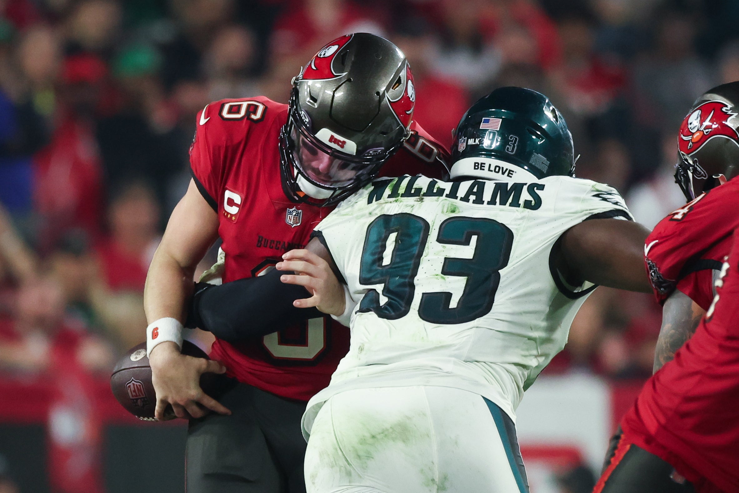 Philadelphia Eagles defensive tackle Milton Williams (93) tackles Tampa Bay Buccaneers quarterback Baker Mayfield (6) during the second half of a 2024 NFC wild card game at Raymond James Stadium.