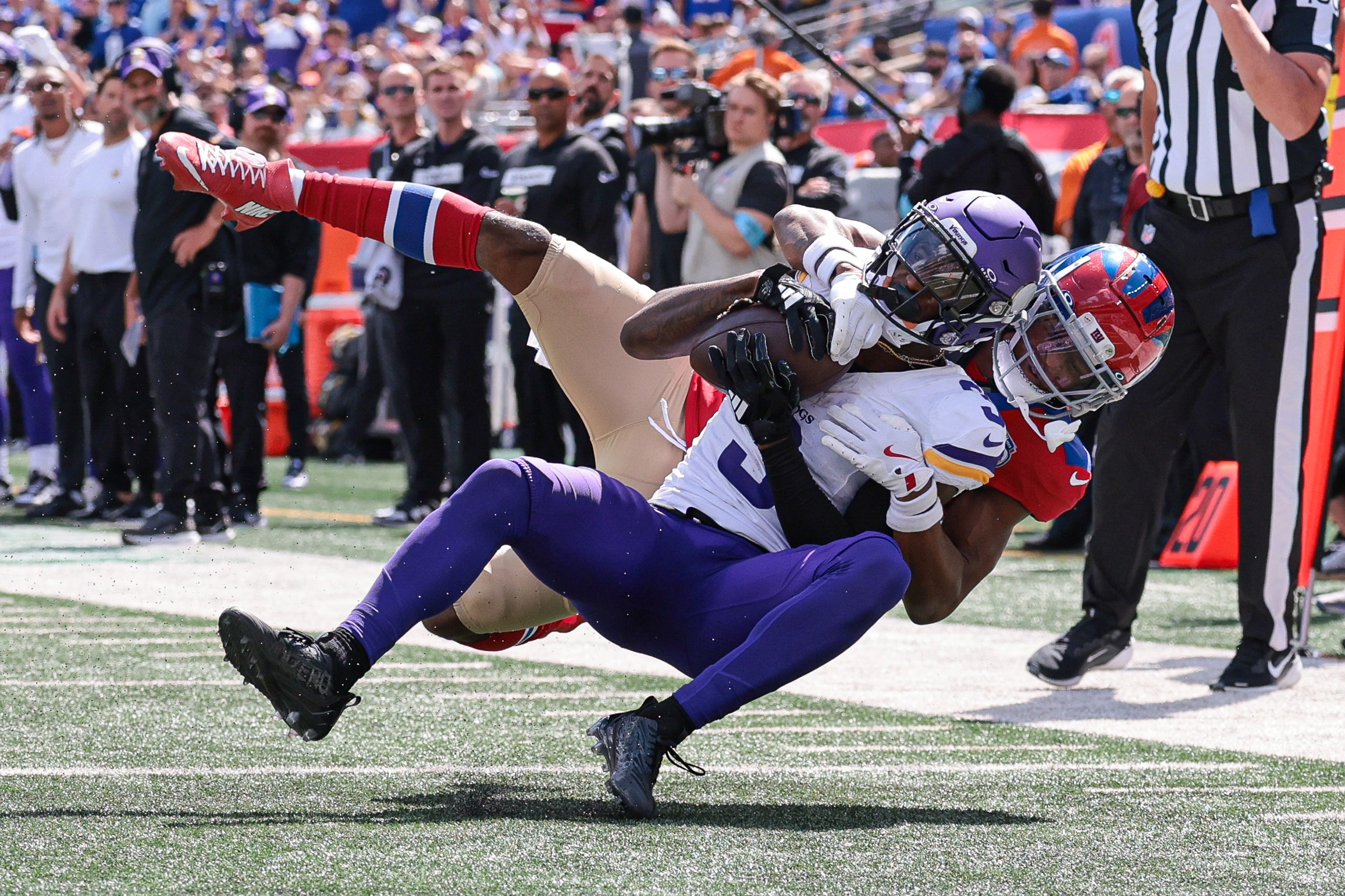 Sep 8, 2024; East Rutherford, New Jersey, USA; Minnesota Vikings wide receiver Jordan Addison (3) is tackled by New York Giants cornerback Dru Phillips (22) during the first half at MetLife Stadium.