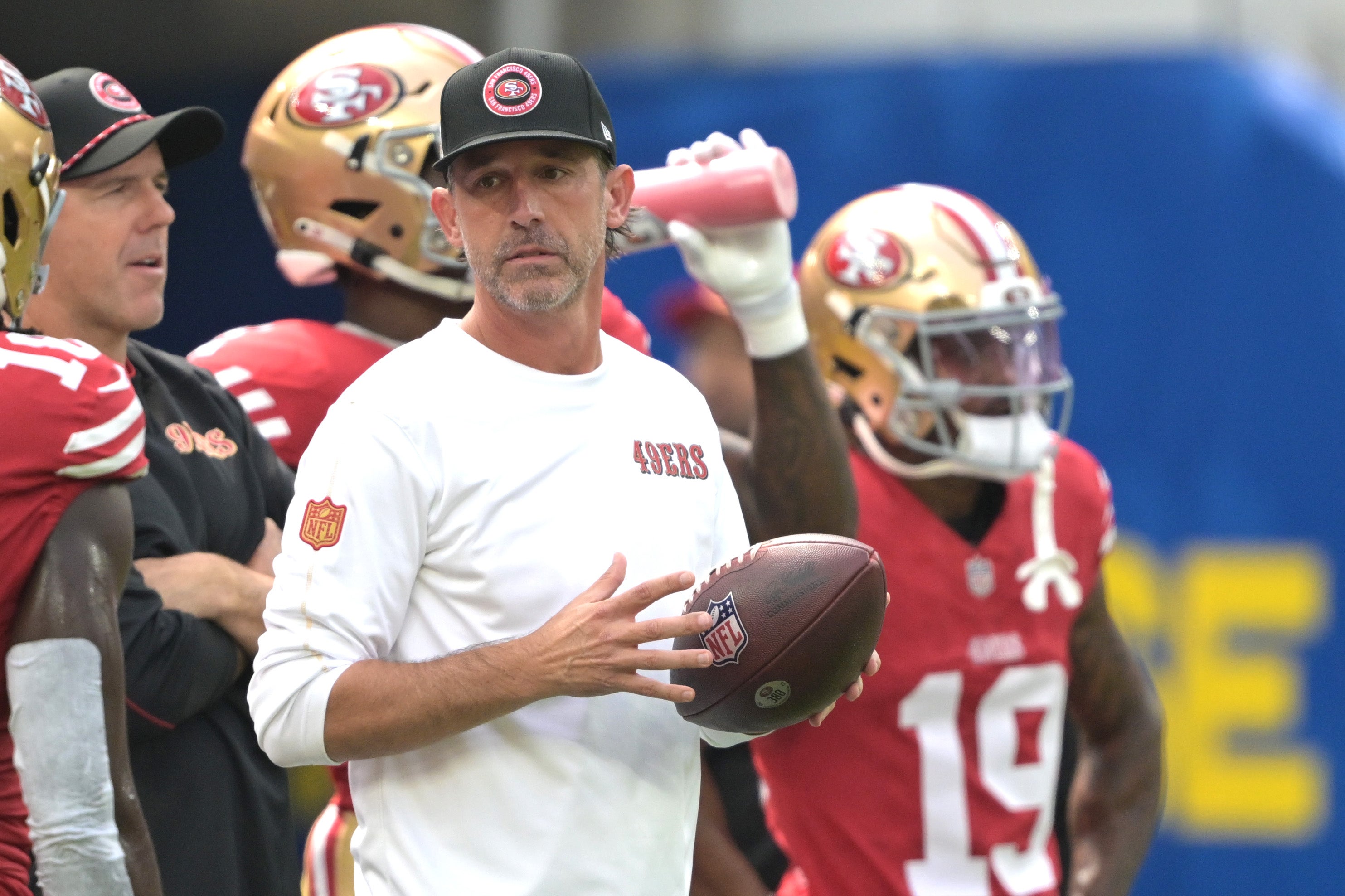San Francisco 49ers head coach Kyle Shanahan looks on as players warm up prior to the game against the Los Angeles Rams at SoFi Stadium.