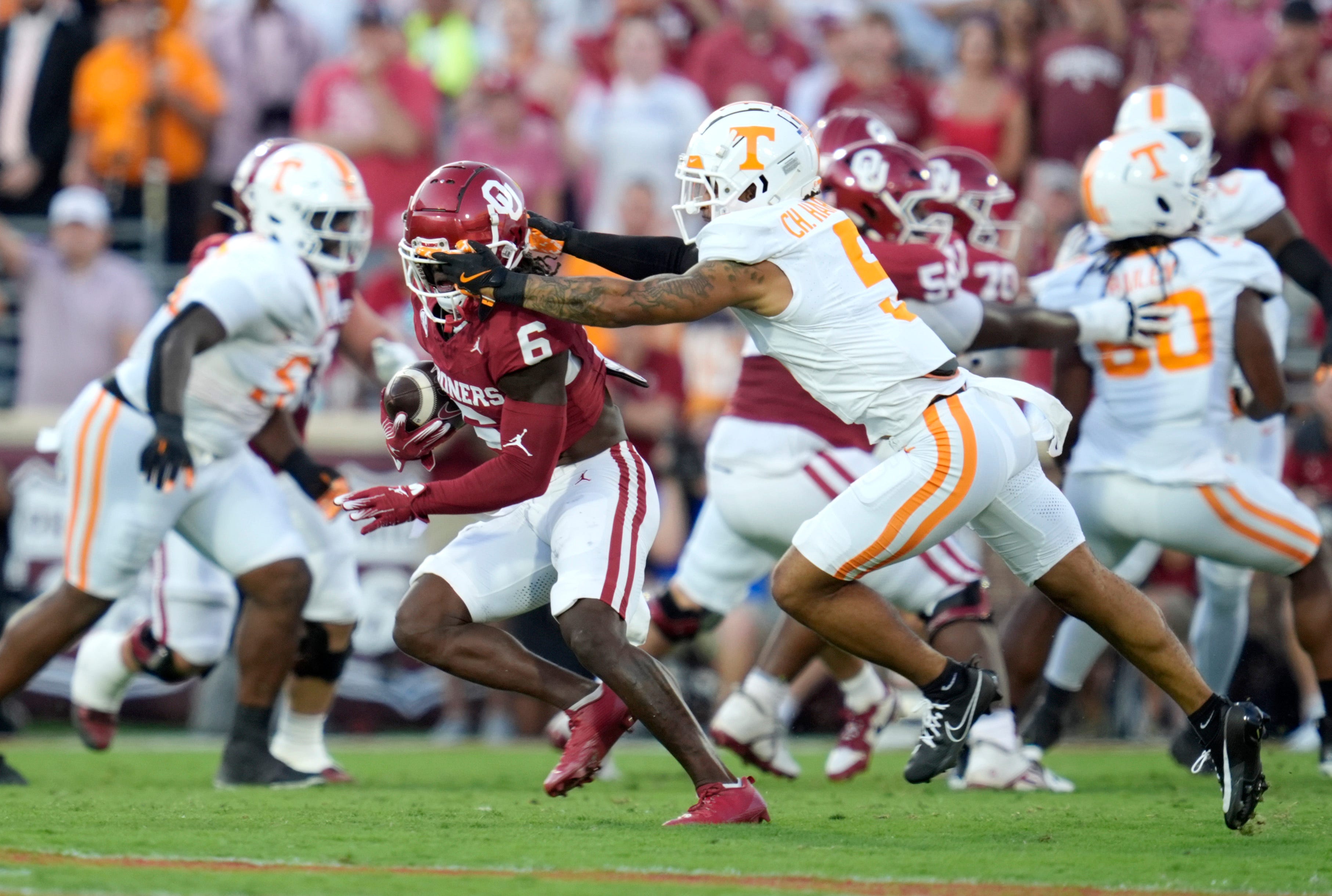 Oklahoma Sooners wide receiver Deion Burks (6) is brought down by Tennessee Volunteers defensive back Christian Harrison (5) during a college football game between the University of Oklahoma Sooners (OU) and the Tennessee Volunteers at Gaylord Family - Oklahoma Memorial Stadium in Norman, Okla., Saturday, Sept. 21, 2024.