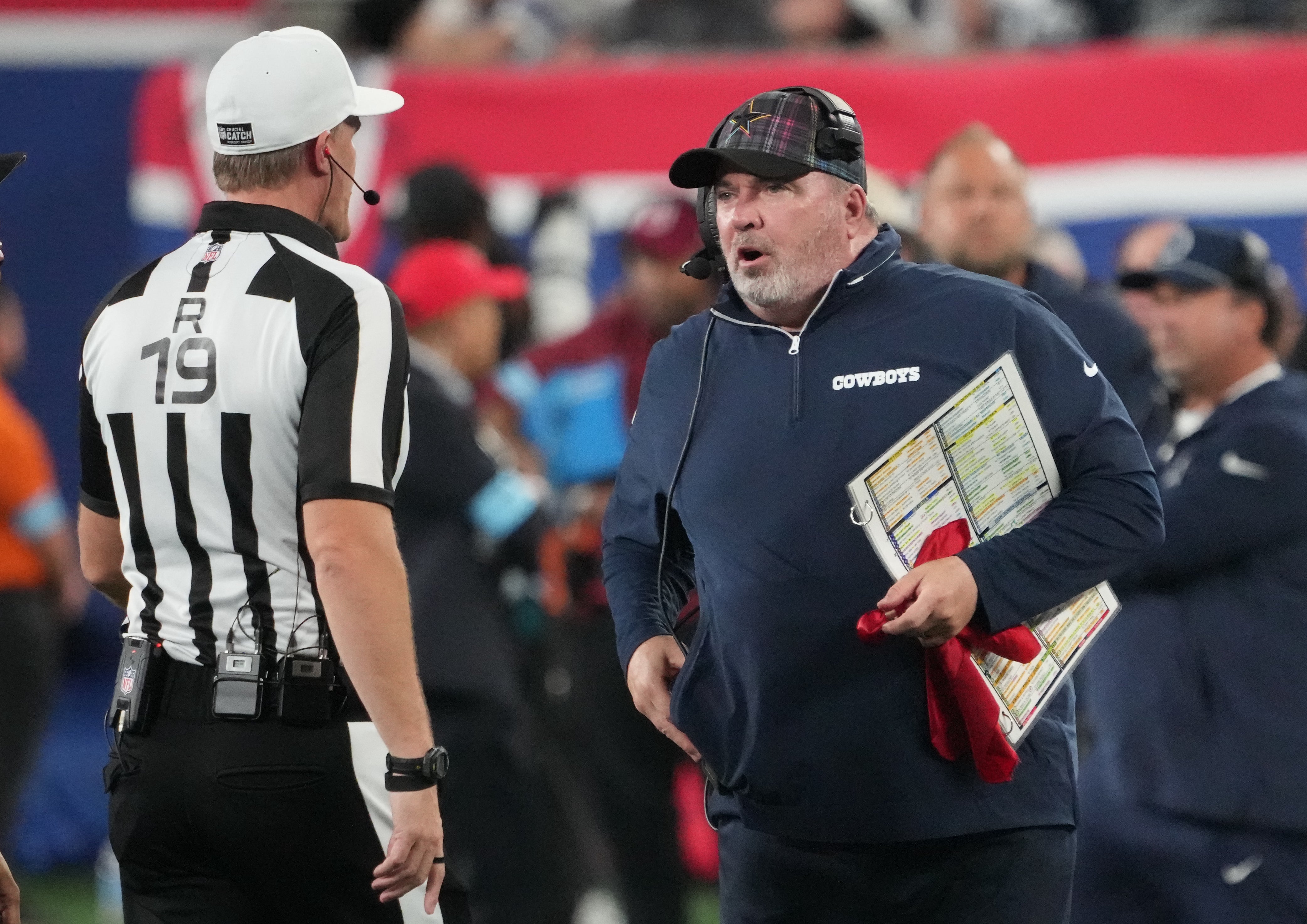 Dallas Cowboys head coach Mike McCarthy and referee Clay Martin (19) talk in th first half against the New York Giants at MetLife Stadium.