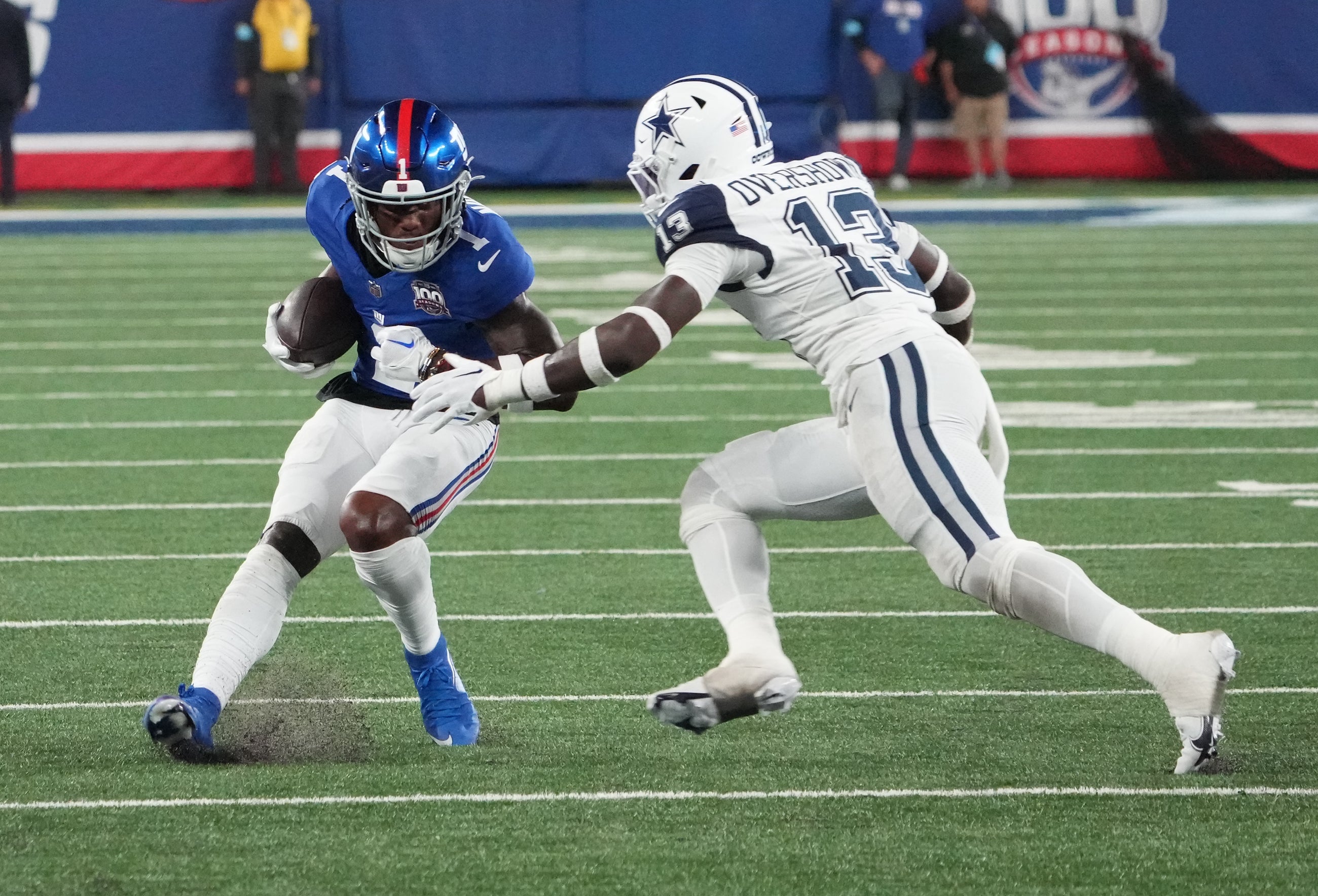 New York Giants wide receiver Malik Nabers (1) on a short gain against Dallas Cowboys linebacker DeMarvion Overshown (13) during the first half at MetLife Stadium.