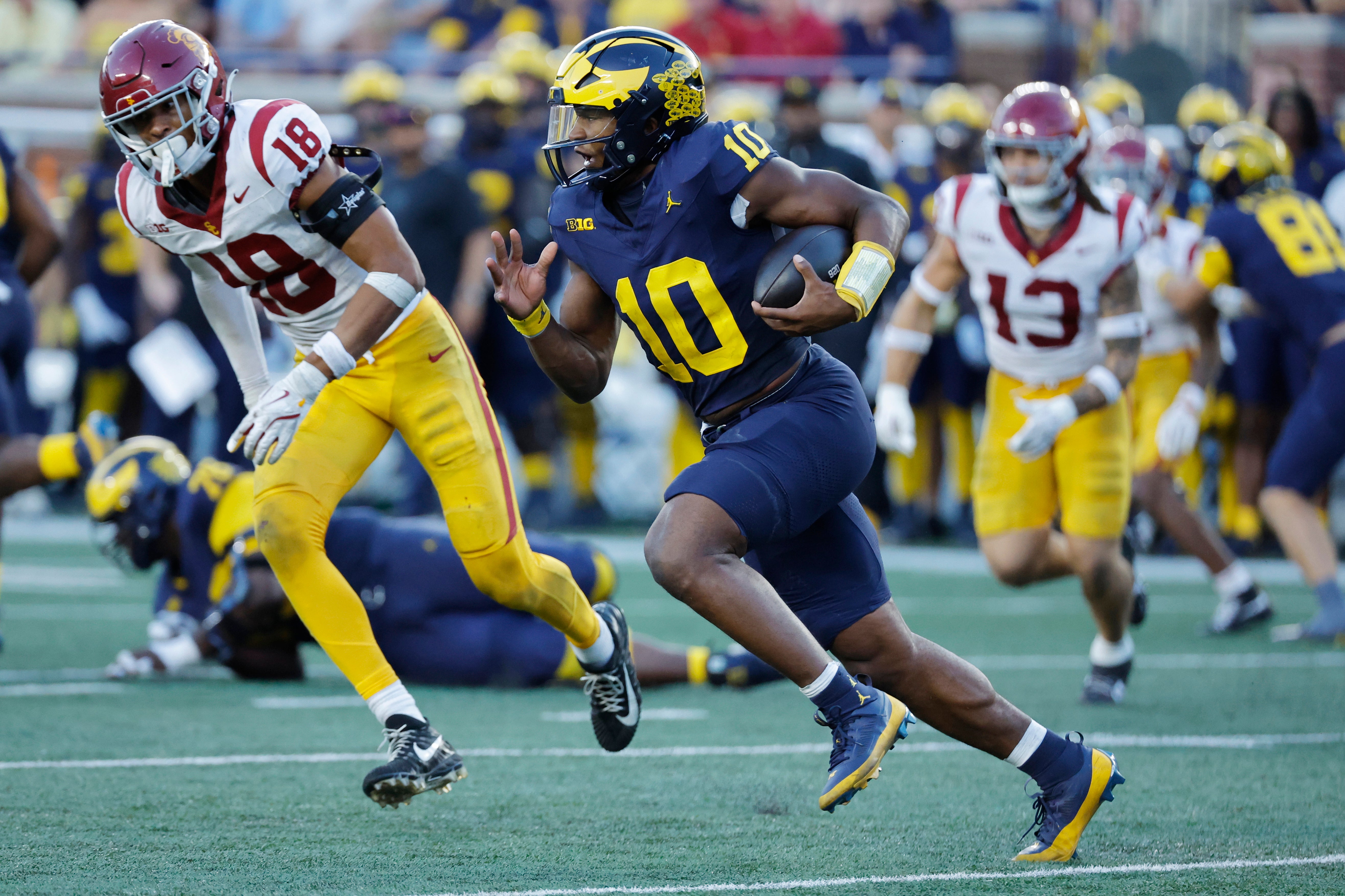 Sep 21, 2024; Ann Arbor, Michigan, USA; Michigan Wolverines quarterback Alex Orji (10) runs in the second half against the USC Trojans at Michigan Stadium.