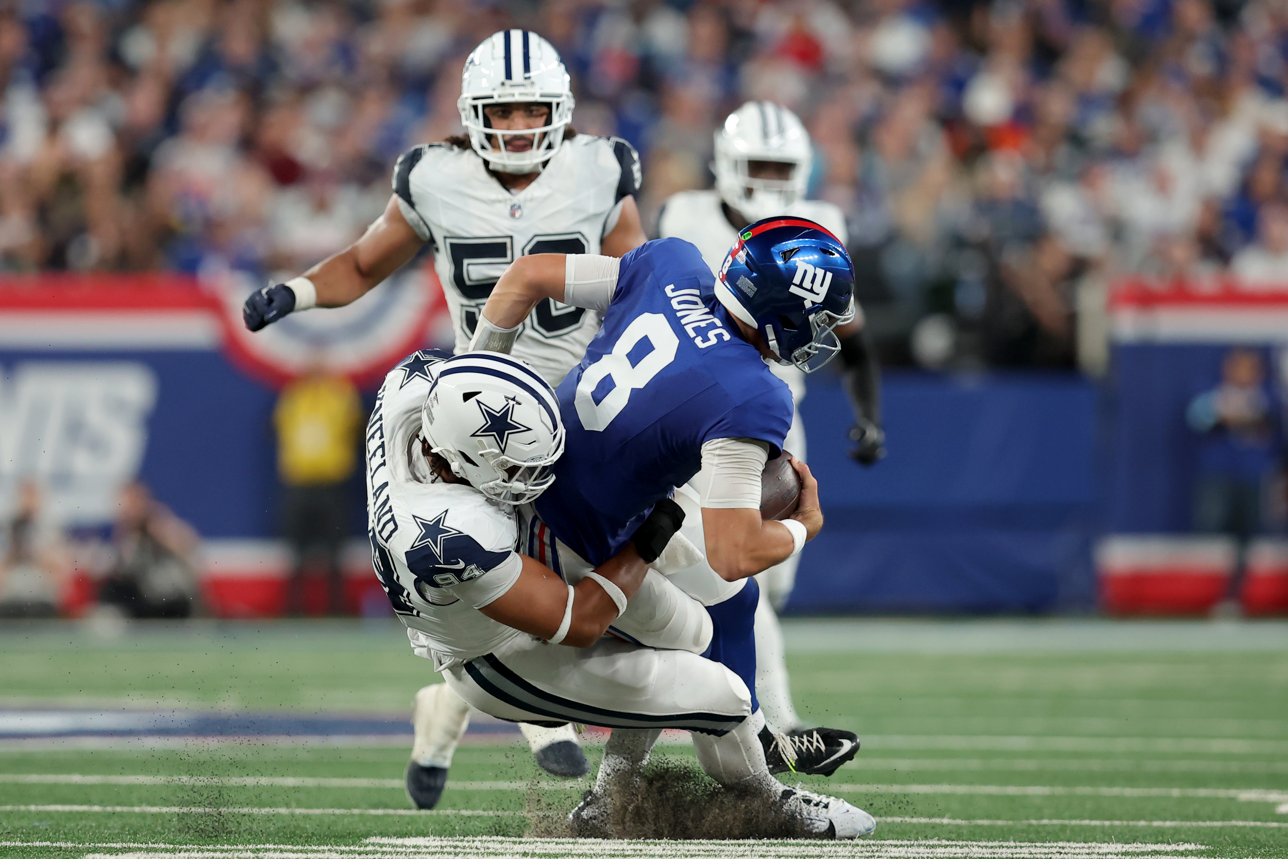 Dallas Cowboys defensive end Marshawn Kneeland (94) sacks New York Giants quarterback Daniel Jones (8) during the third quarter at MetLife Stadium.