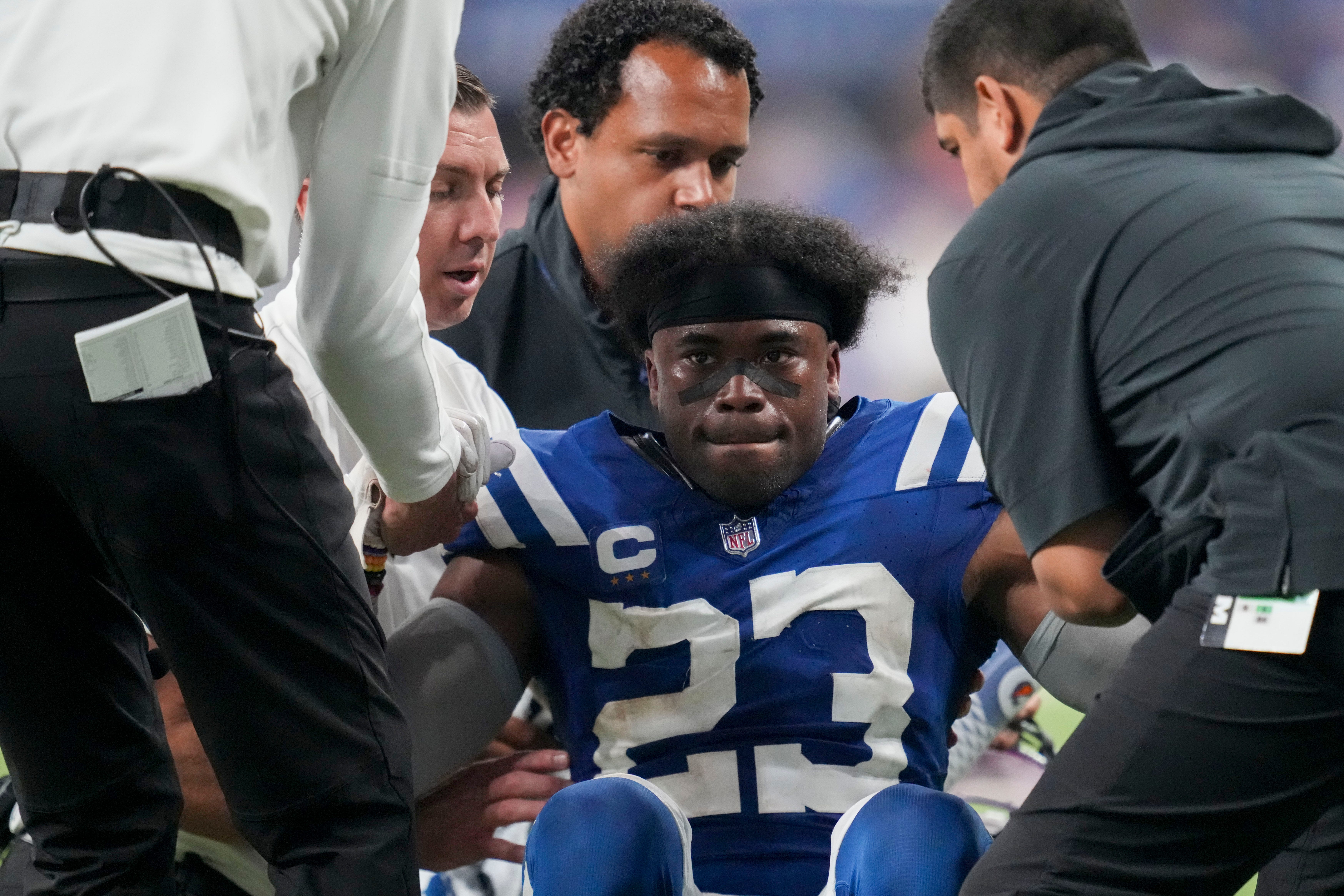Indianapolis Colts cornerback Kenny Moore II (23) is helped to his feet following an injury on the field Sunday, Sept. 22, 2024, during a game against the Chicago Bears at Lucas Oil Stadium in Indianapolis.