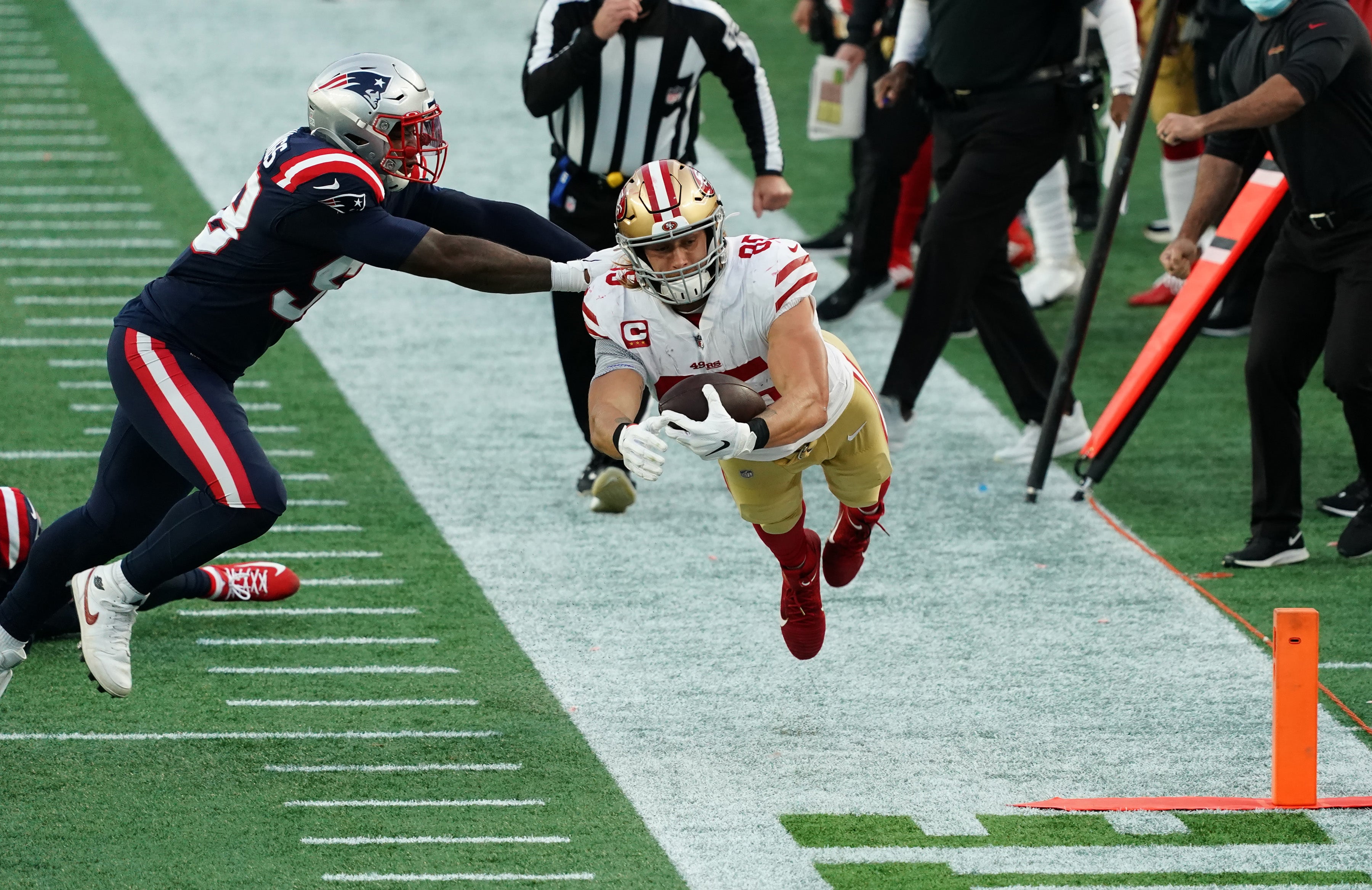 San Francisco 49ers tight end George Kittle (85) works for the extra yards against the New England Patriots in the first half at Gillette Stadium.