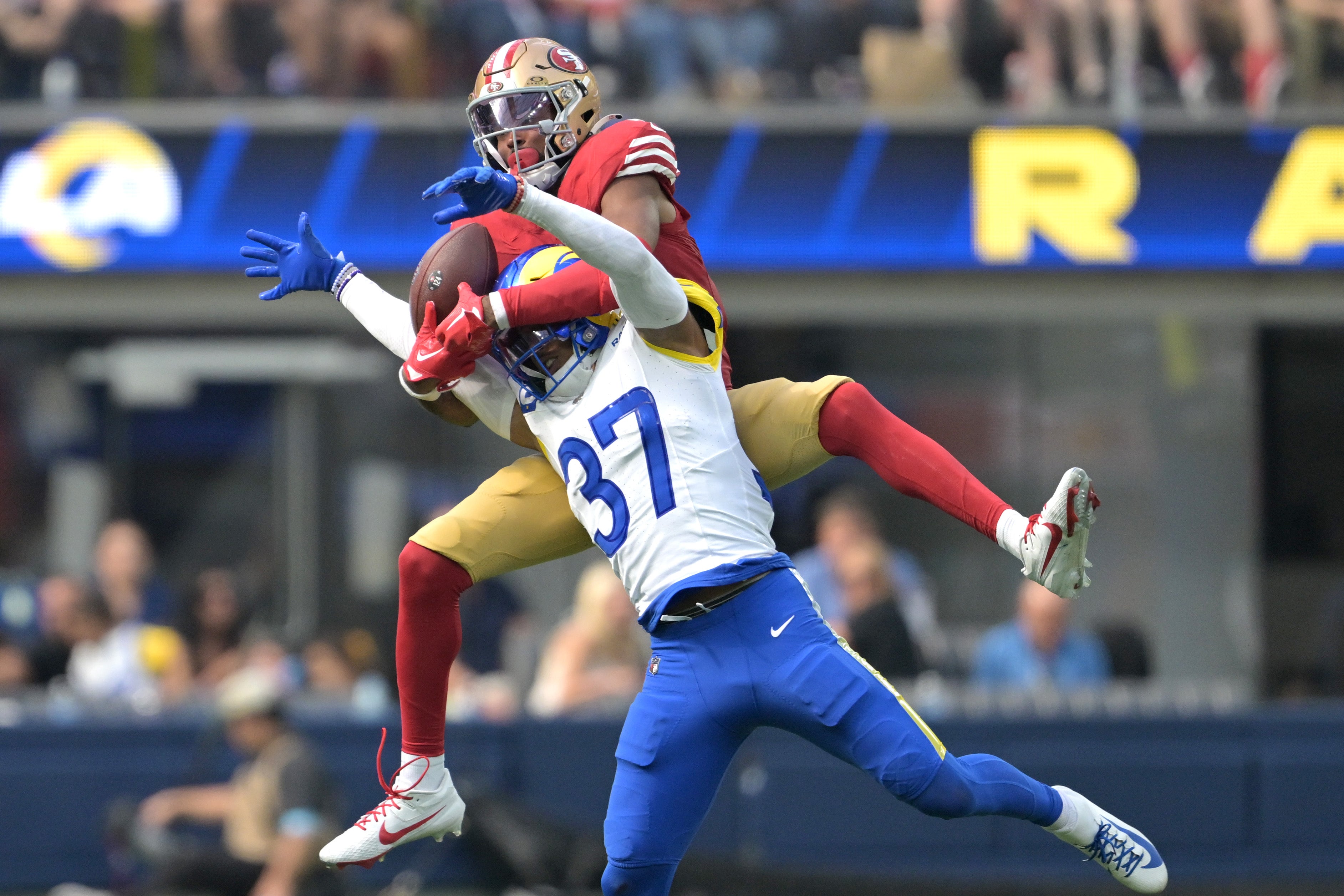 Los Angeles Rams safety Quentin Lake (37) and San Francisco 49ers wide receiver Jauan Jennings (15) compete for a pass in the second half at SoFi Stadium.