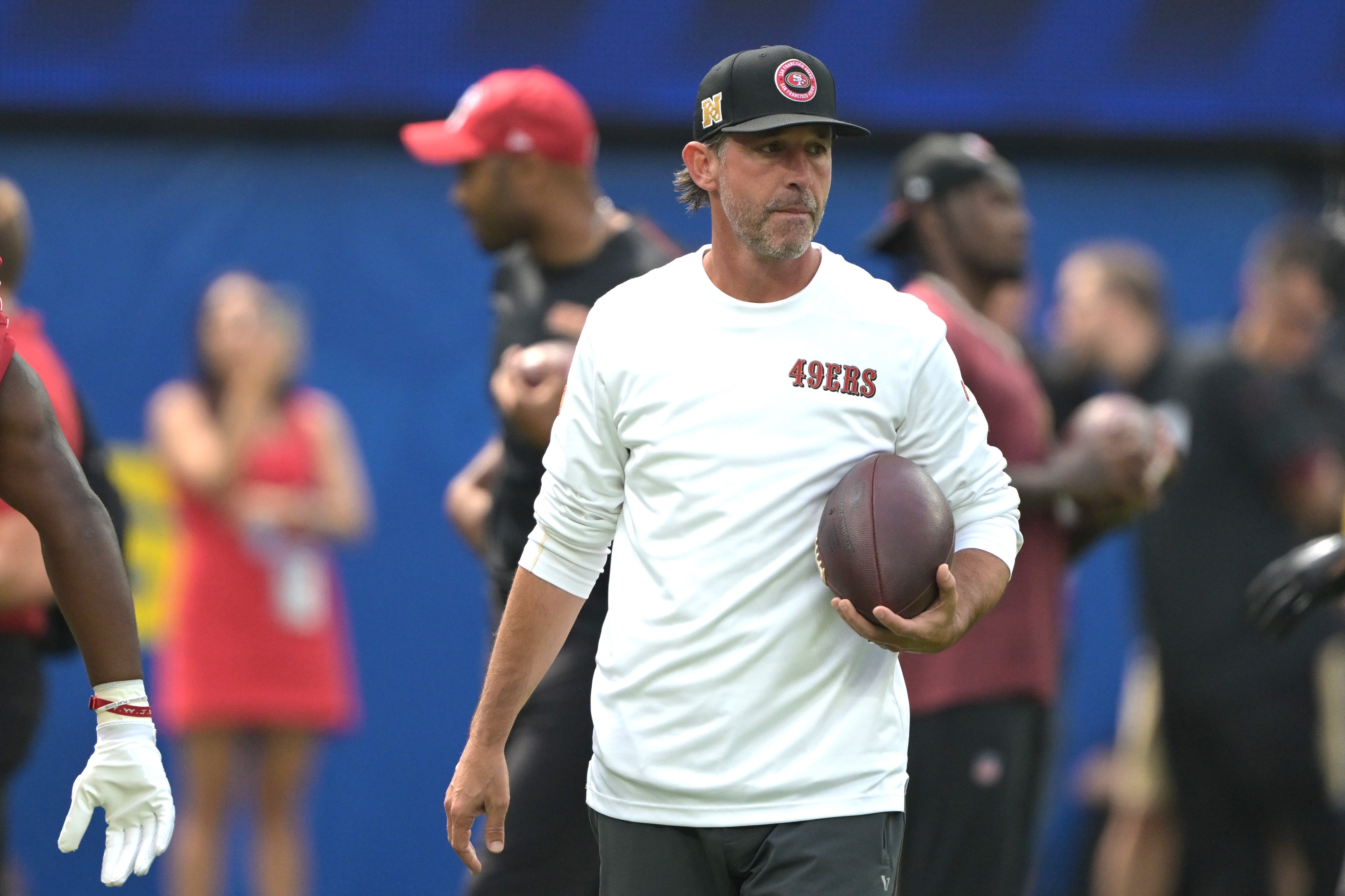 San Francisco 49ers head coach Kyle Shanahan looks on as players warm up prior to the game against the Los Angeles Rams at SoFi Stadium.
