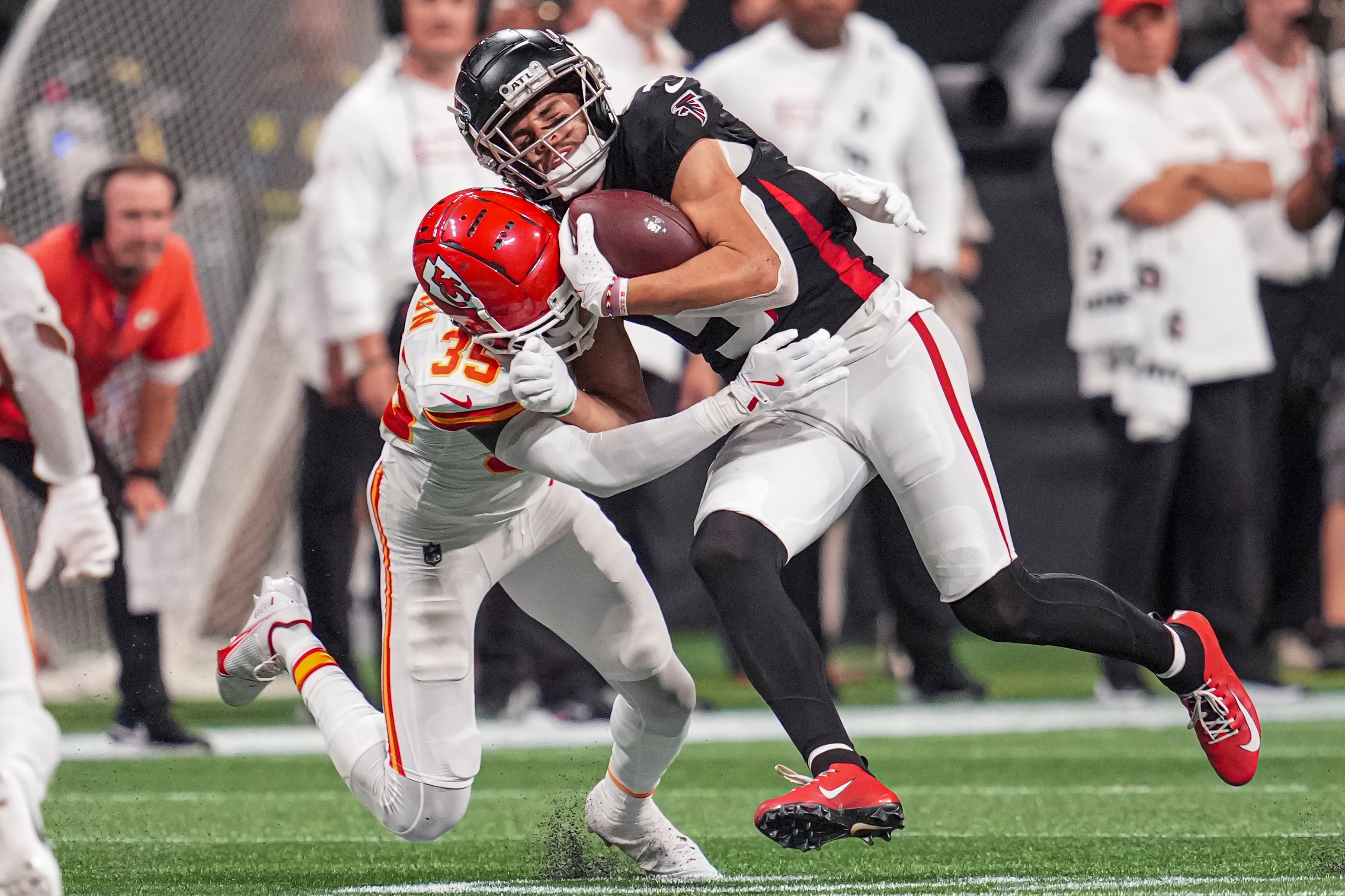 Falcons wide receiver Drake London is hit by Chiefs cornerback Jaylen Watson.