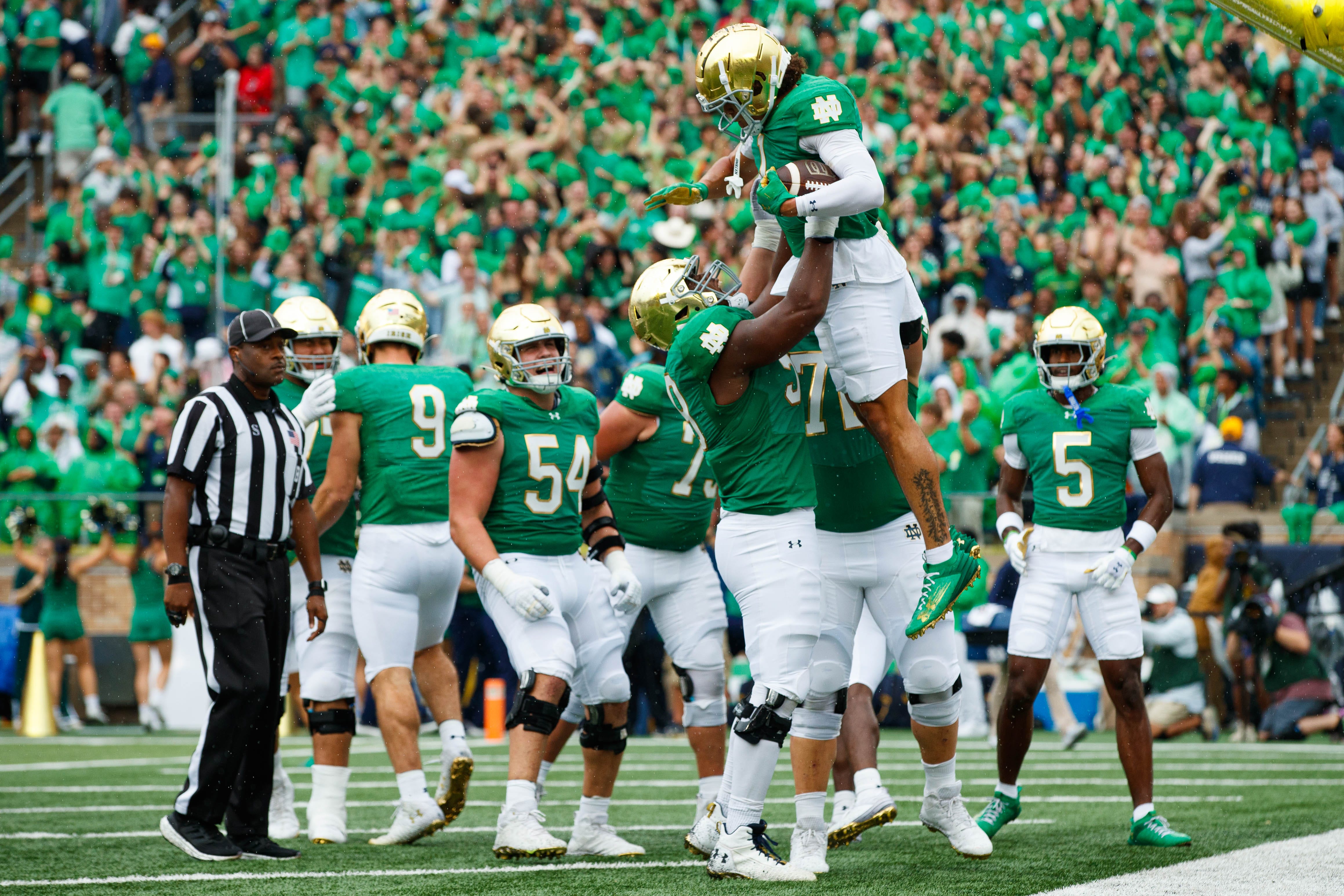 Notre Dame wide receiver Jaden Greathouse hauls in a touchdown against Louisville.