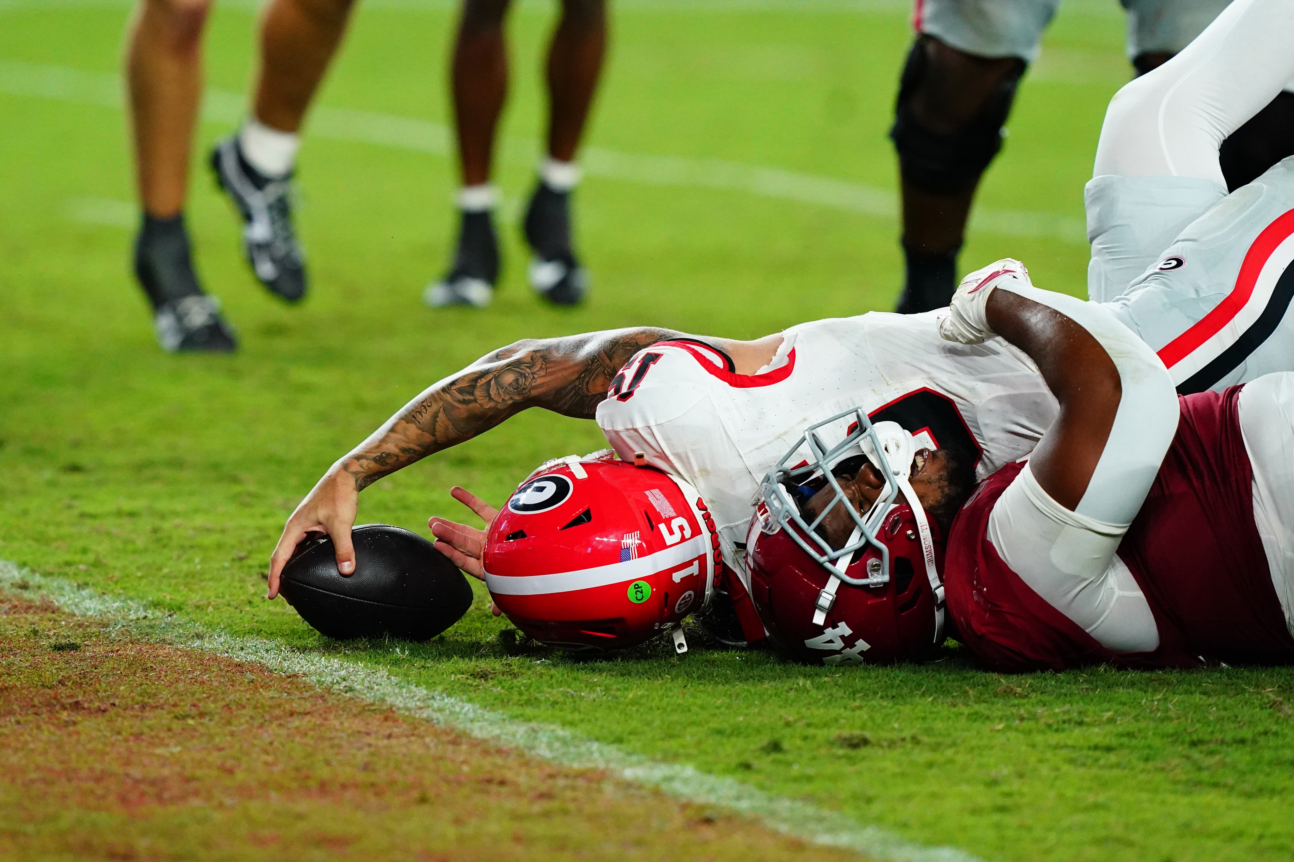 Sep 28, 2024; Tuscaloosa, Alabama, USA; Georgia Bulldogs quarterback Carson Beck (15) is held back from the goaline by Alabama Crimson Tide defensive lineman Damon Payne Jr. (44) on a two point conversion during the fourth quarter at Bryant-Denny Stadium.