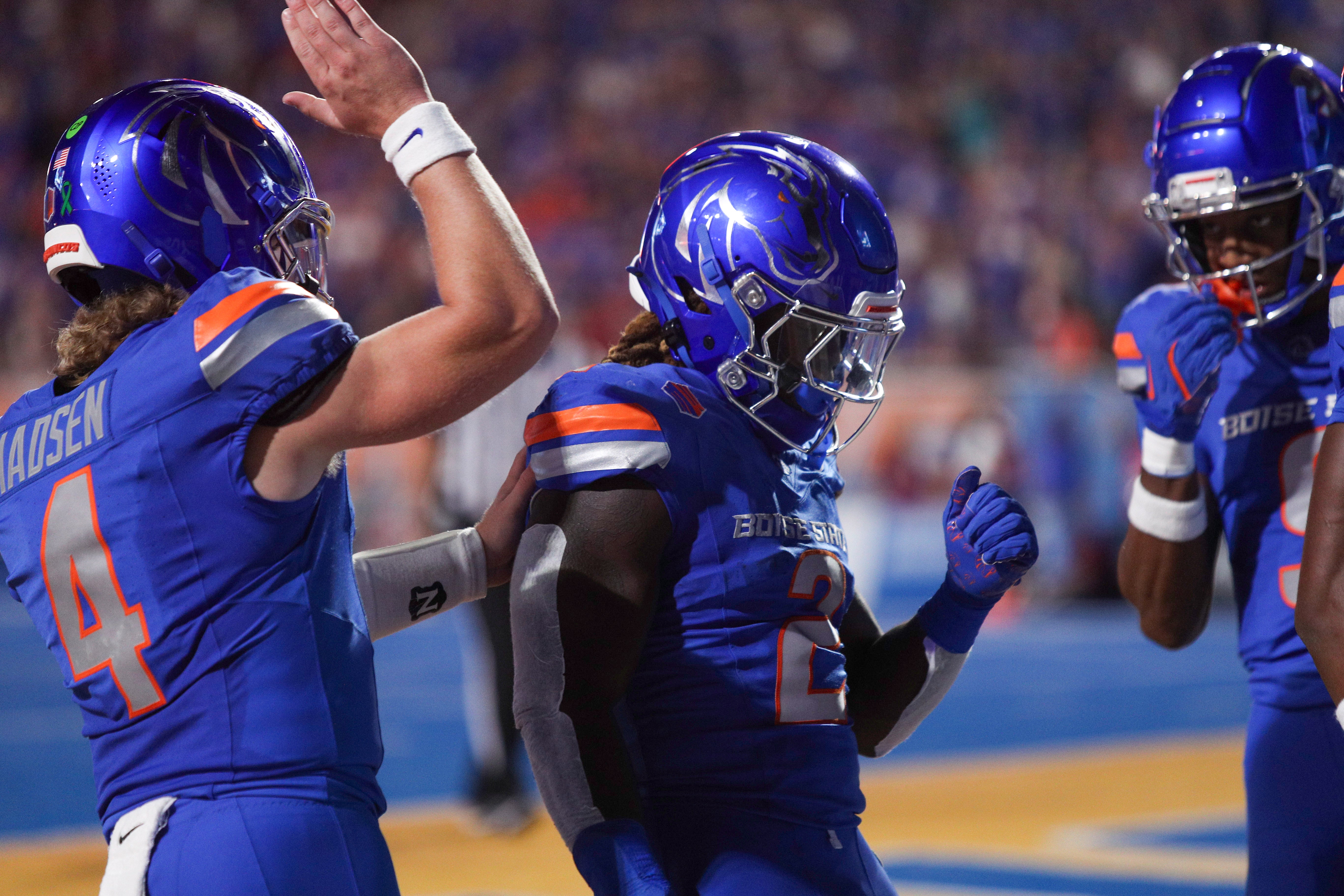 Sep 28, 2024; Boise, Idaho, USA; Boise State Broncos running back Ashton Jeanty (2) and Boise State Broncos quarterback Maddux Madsen (4) celebrate after scoring Jeanty's 64-yard touchdown run in the first quarter versus the Washington State Cougars at Albertsons Stadium. Mandatory Credit: Brian Losness-Imagn Images