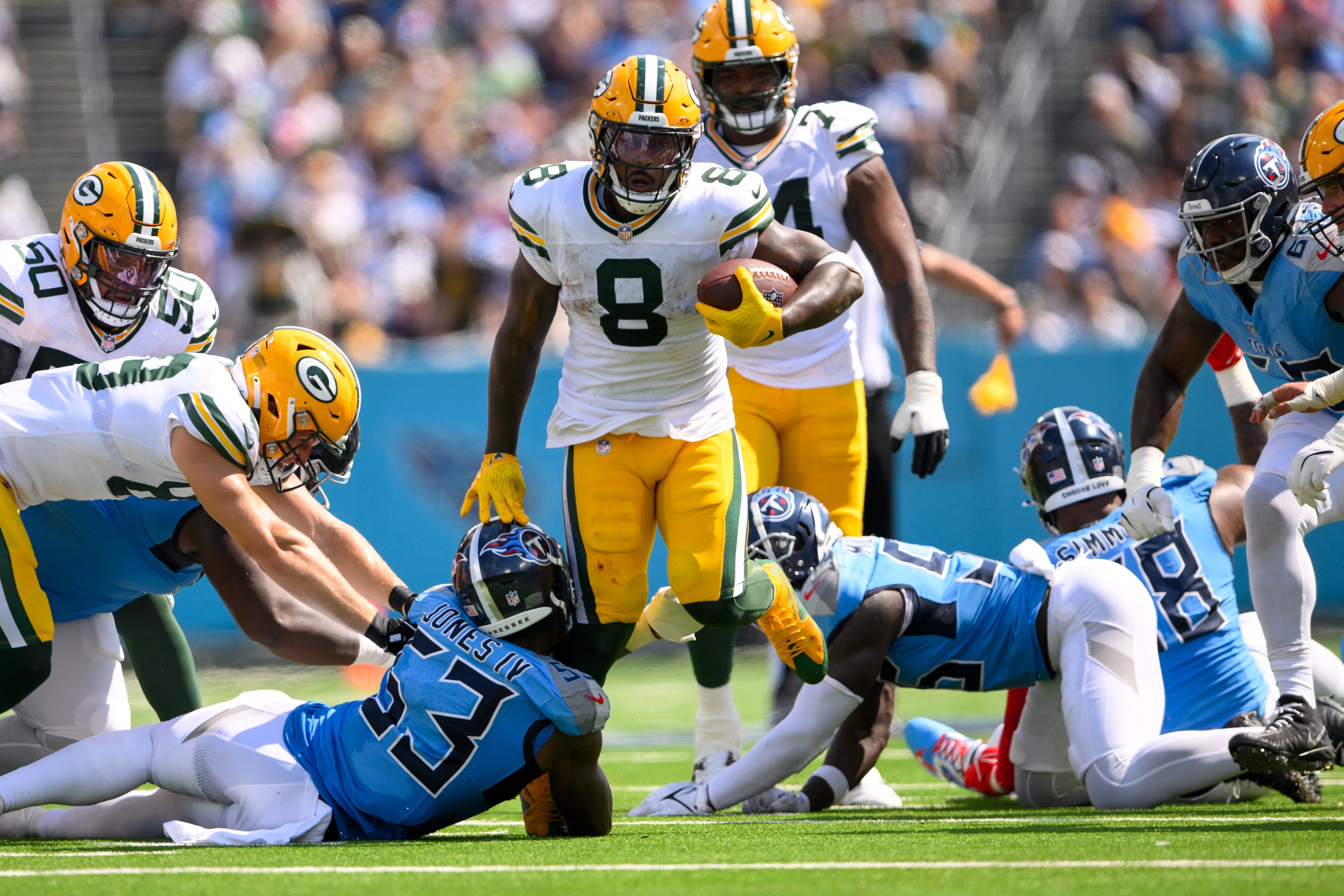 Sep 22, 2024; Nashville, Tennessee, USA; Green Bay Packers running back Josh Jacobs (8) breaks the tackle of Tennessee Titans linebacker Ernest Jones IV during the second half at Nissan Stadium.