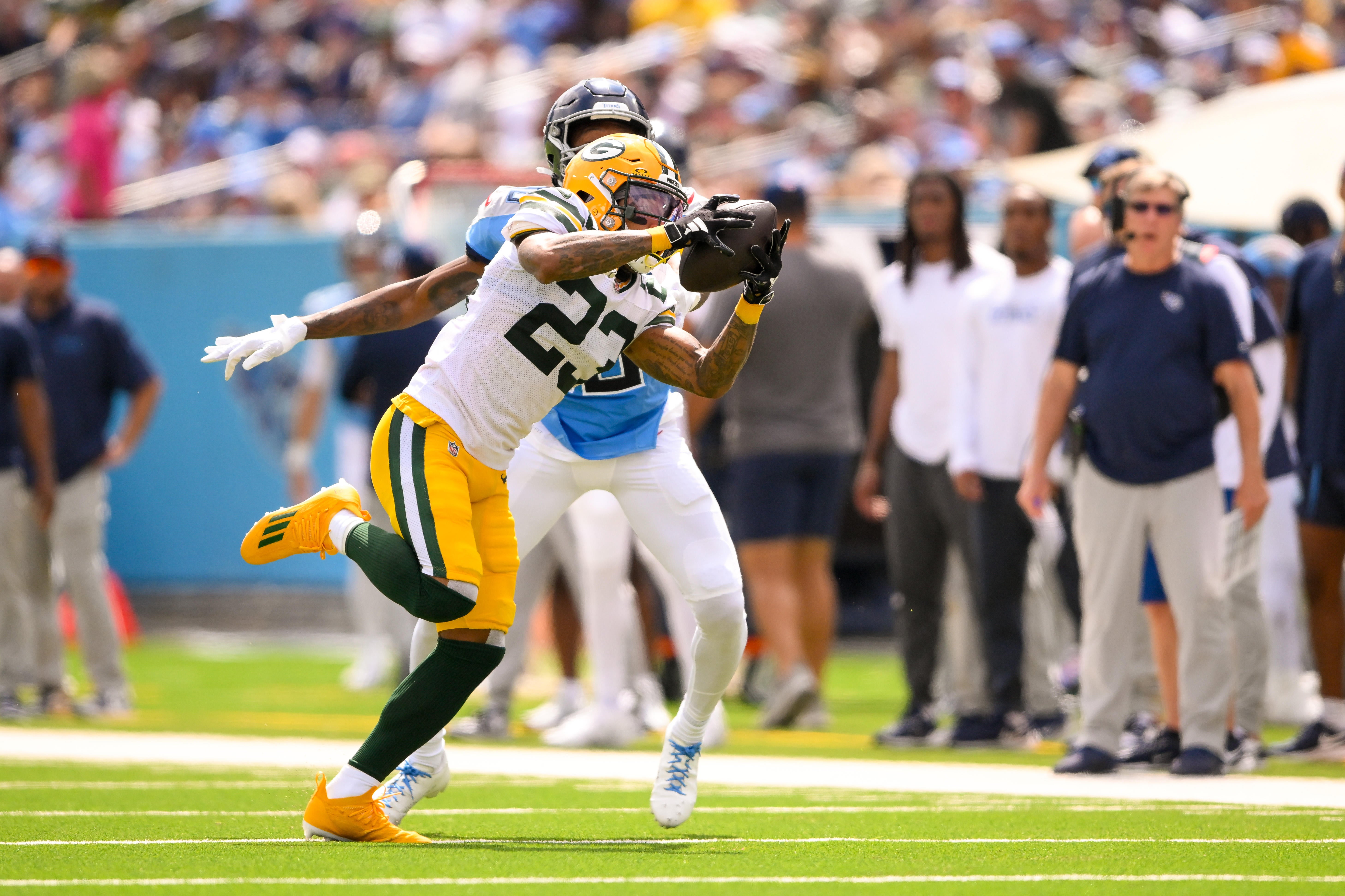 Green Bay Packers cornerback Jaire Alexander (23) intercepts a pass thrown by Tennessee Titans Will Levis (8) during the first half at Nissan Stadium.
