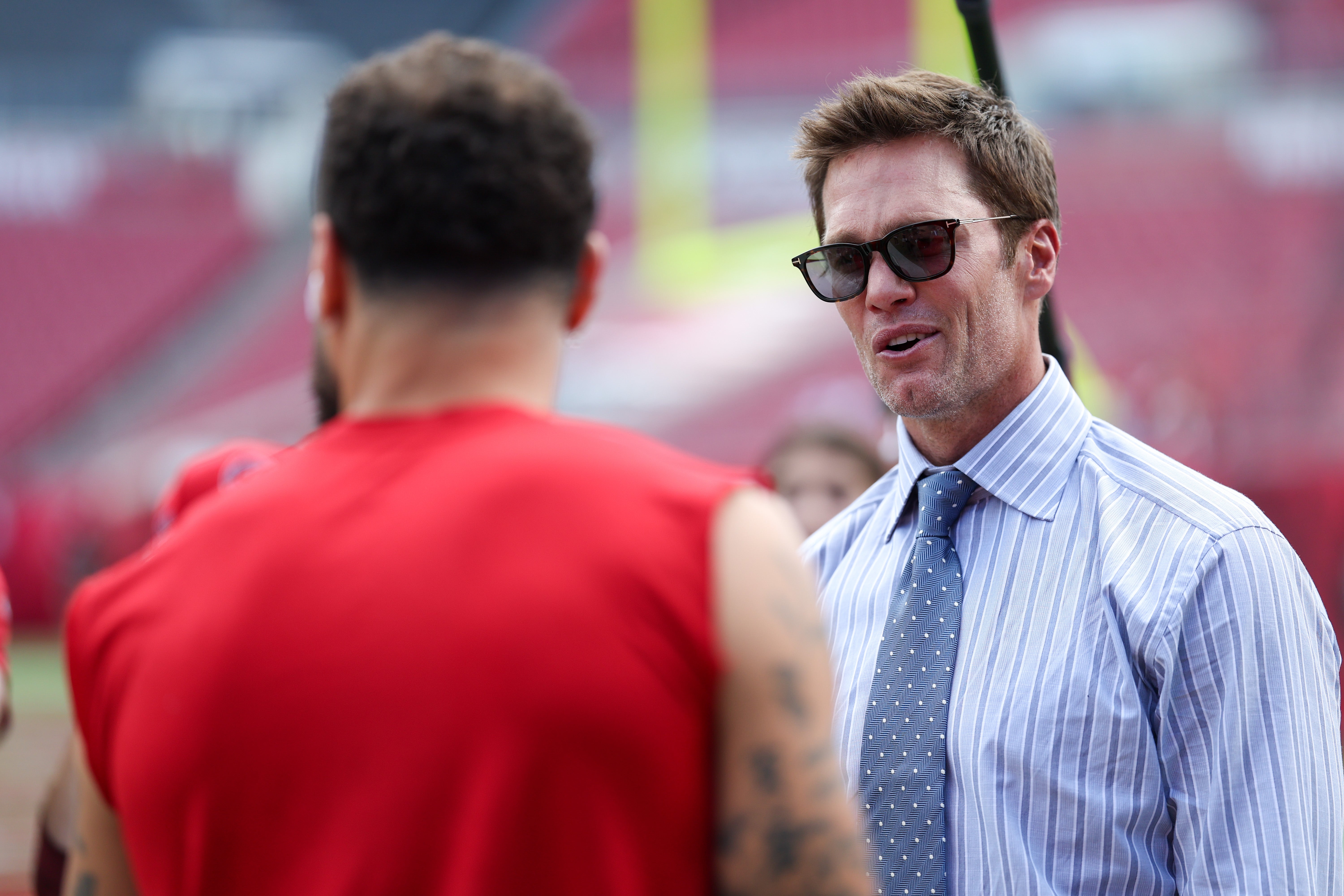 Sep 29, 2024; Tampa, Florida, USA; Fox NFL broadcaster and former NFL quarterback Tom Brady speaks to Tampa Bay Buccaneers wide receiver Mike Evans (13) before a game against the Philadelphia Eagles at Raymond James Stadium.