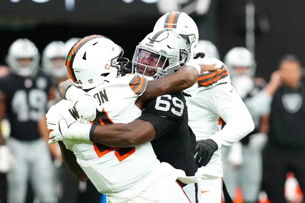 Las Vegas Raiders defensive tackle Adam Butler (69) tackles Cleveland Browns quarterback Deshaun Watson (4) during the first quarter at Allegiant Stadium.
