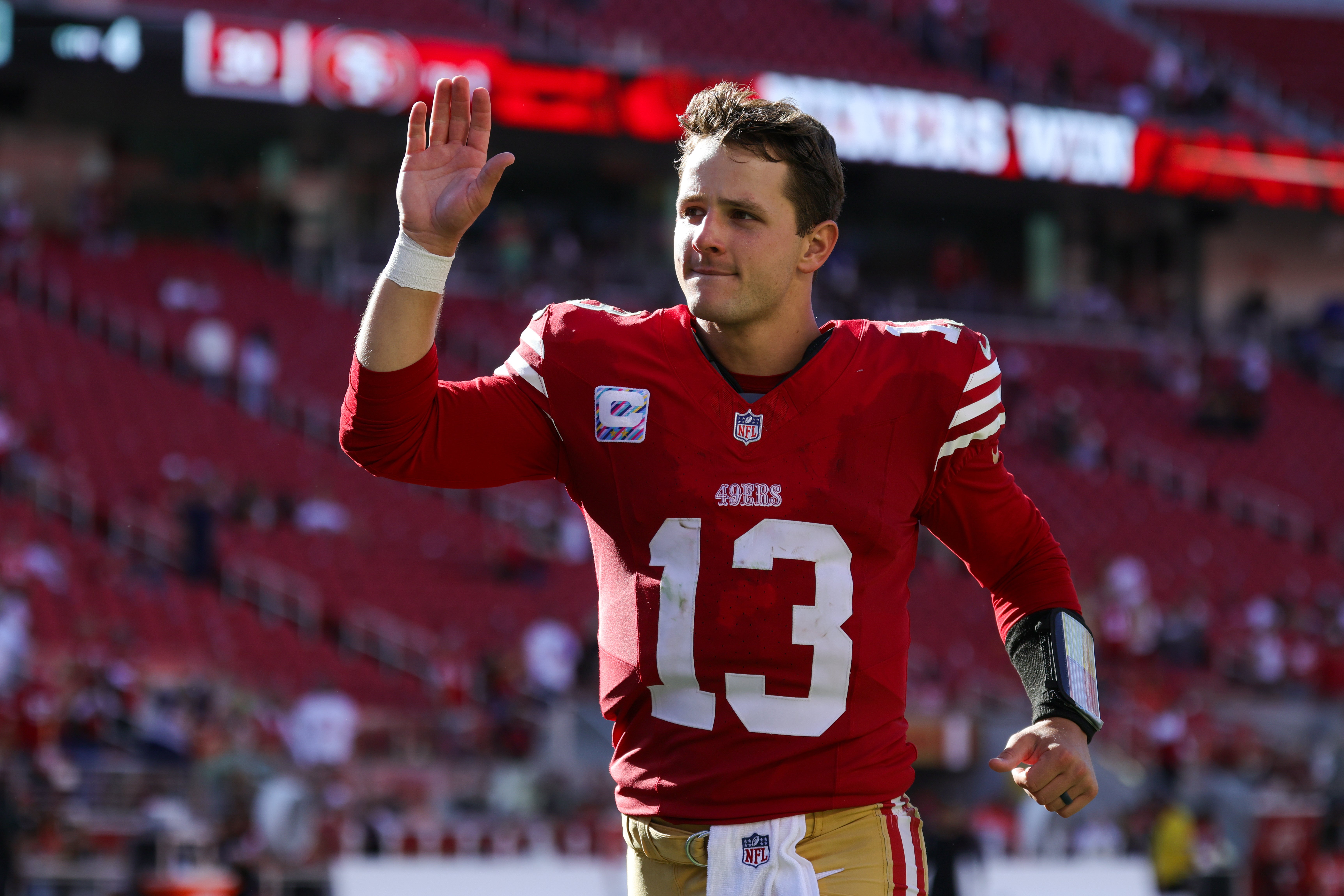 San Francisco 49ers quarterback Brock Purdy (13) runs off the field after the game against the New England Patriots at Levi's Stadium.