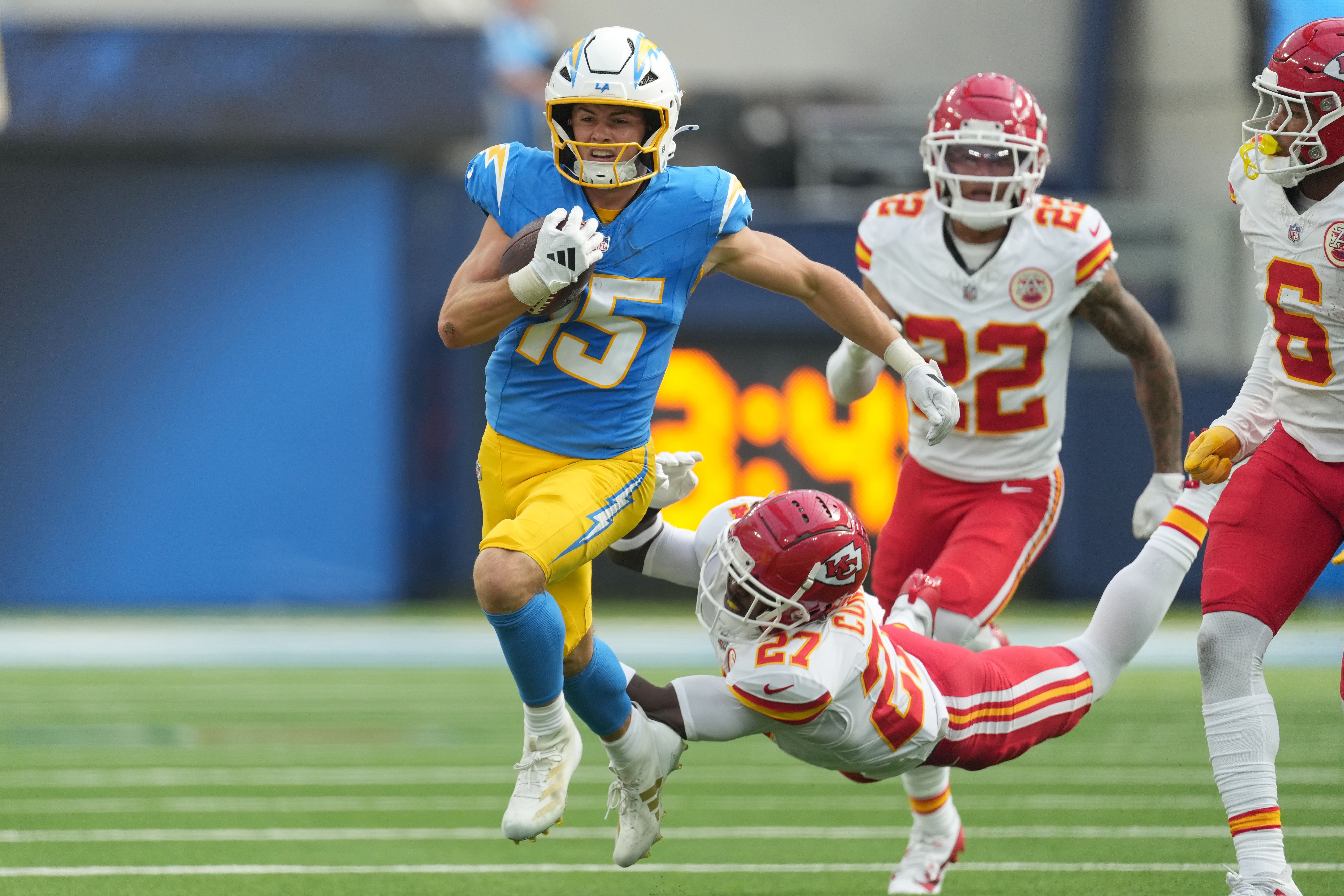Los Angeles Chargers wide receiver Ladd McConkey (15) carries the ball on a 37-yard reception against Kansas City Chiefs safety Chamarri Conner (27) in the second half at SoFi Stadium.