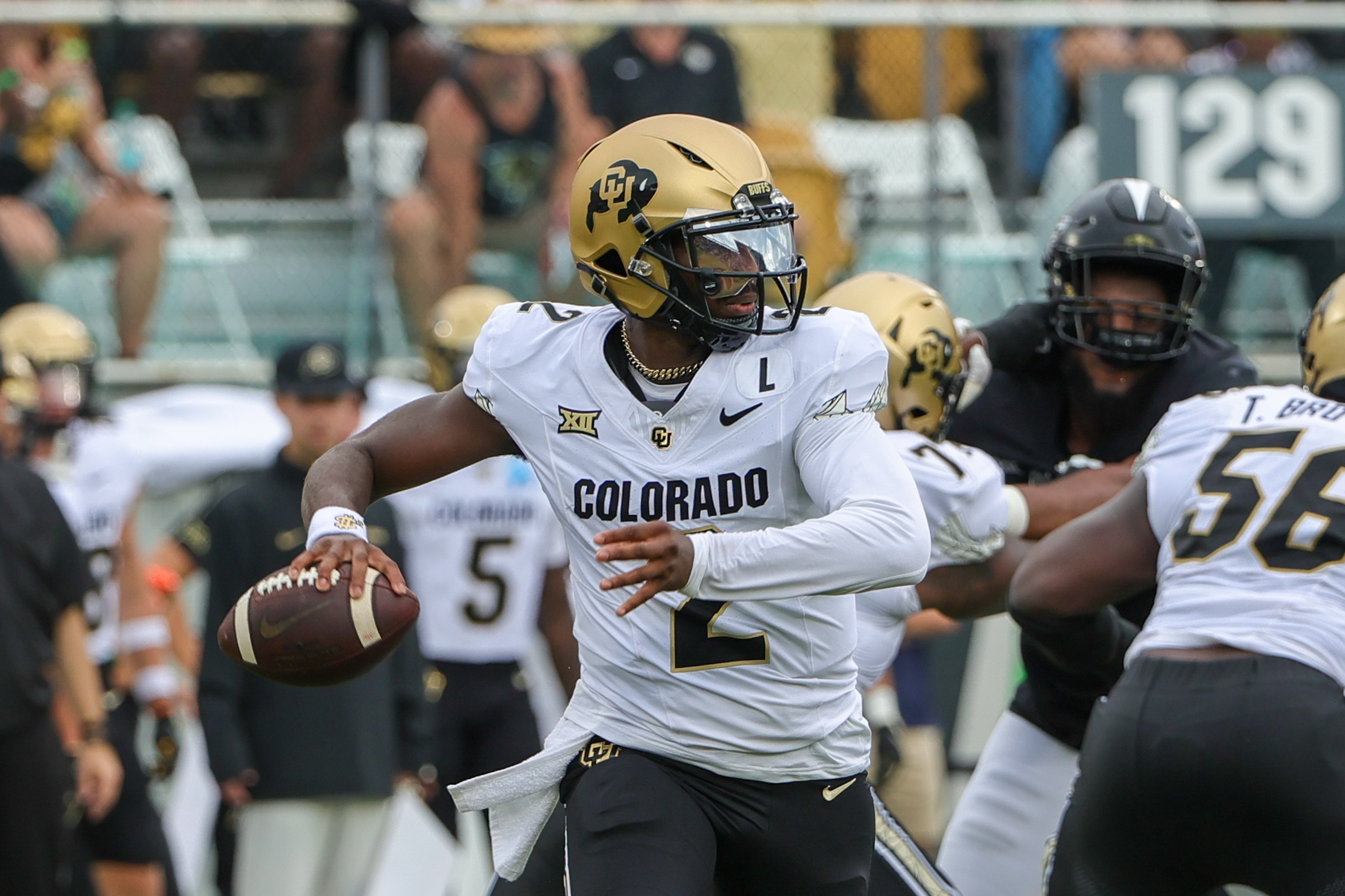 Colorado Buffaloes quarterback Shedeur Sanders (2) rolls out to pass against the UCF Knights.