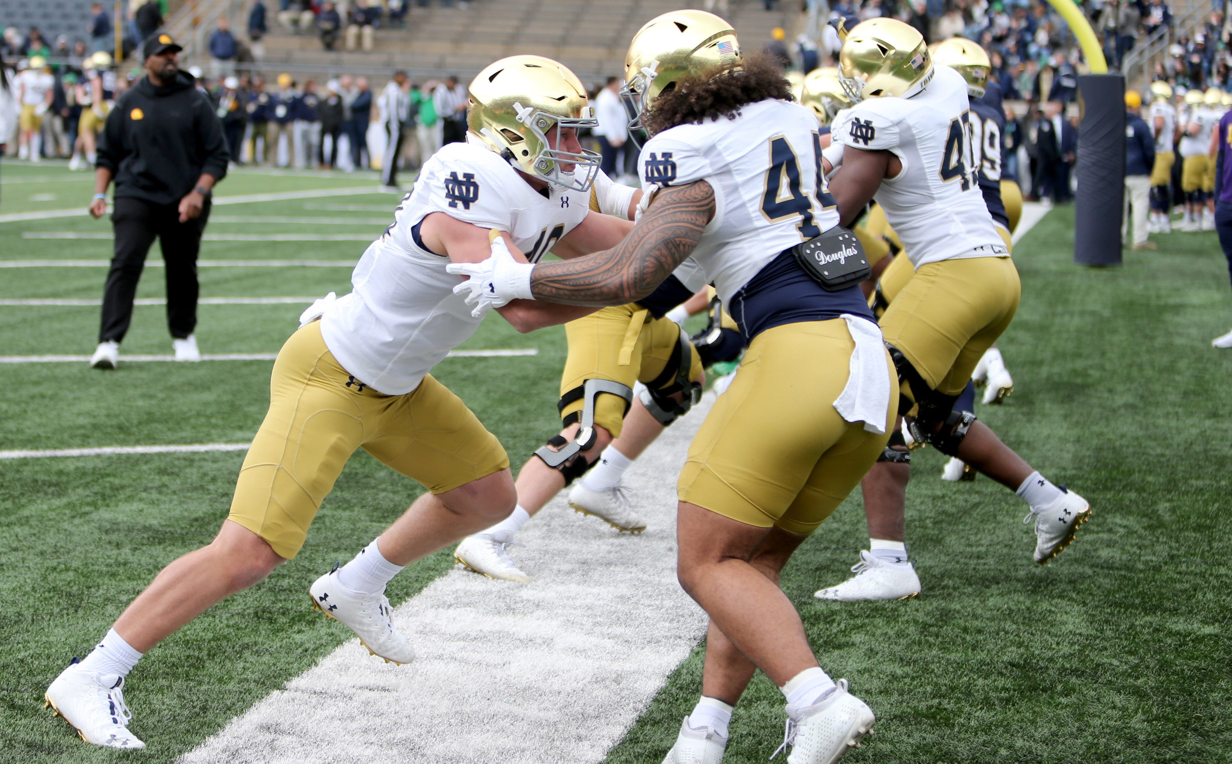 Notre Dame defensive linemen Joshua Burnham (40) and Junior Tuihalamaka (44) working pregame.