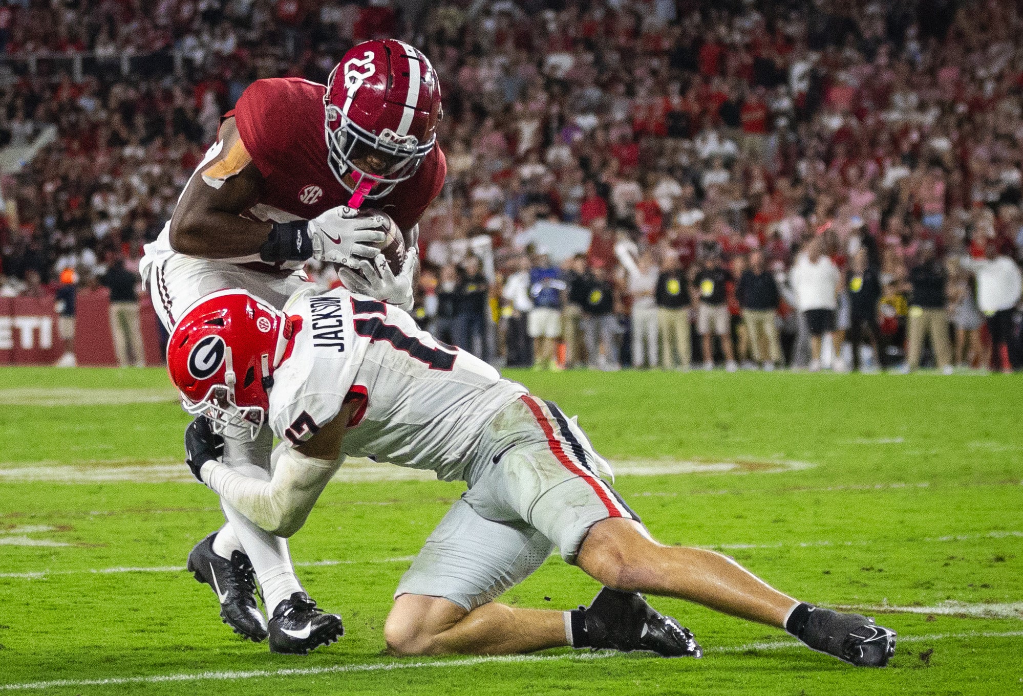 Alabama Crimson Tide running back Justice Haynes (22) is stopped by Georgia Bulldogs defensive back Dan Jackson (17) during the third quarter at Bryant-Denny Stadium.