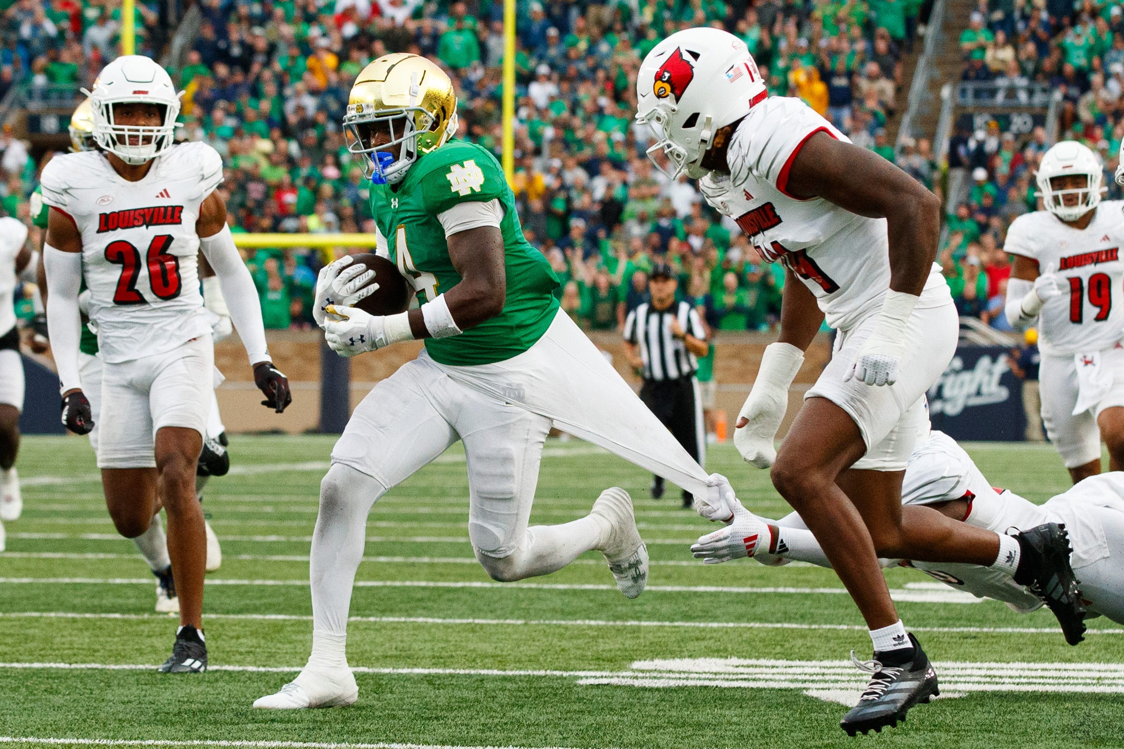 Notre Dame running back Jeremiyah Love (4) breaks free from a tackle on his way to score a touchdown during a NCAA college football game between Notre Dame and Louisville at Notre Dame Stadium on Saturday, Sept. 28, 2024, in South Bend.