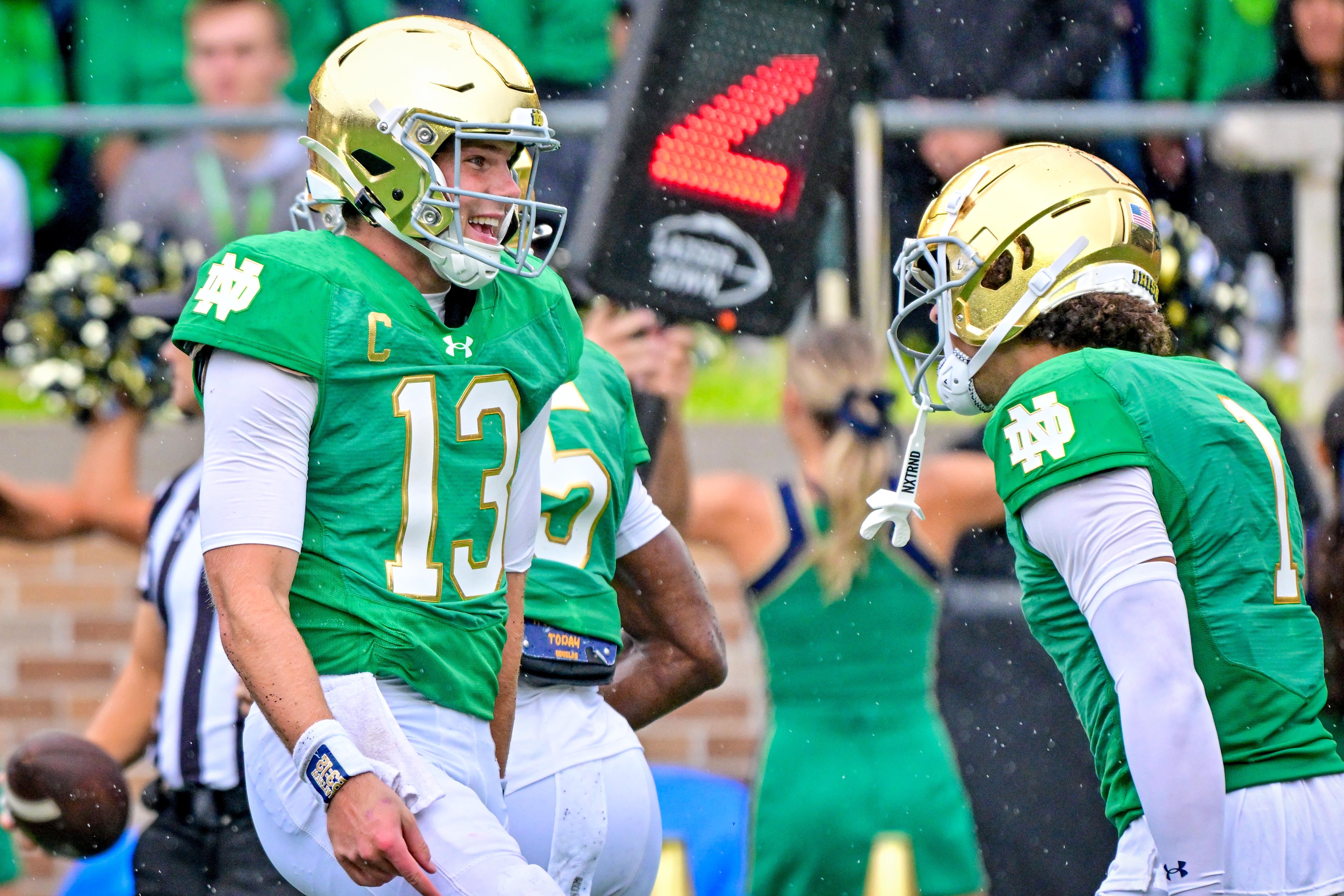 Notre Dame Fighting Irish quarterback Riley Leonard (13) celebrates with wide receiver Jaden Greathouse (1) after a touchdown against the Louisville Cardinals in the first quarter at Notre Dame Stadium.