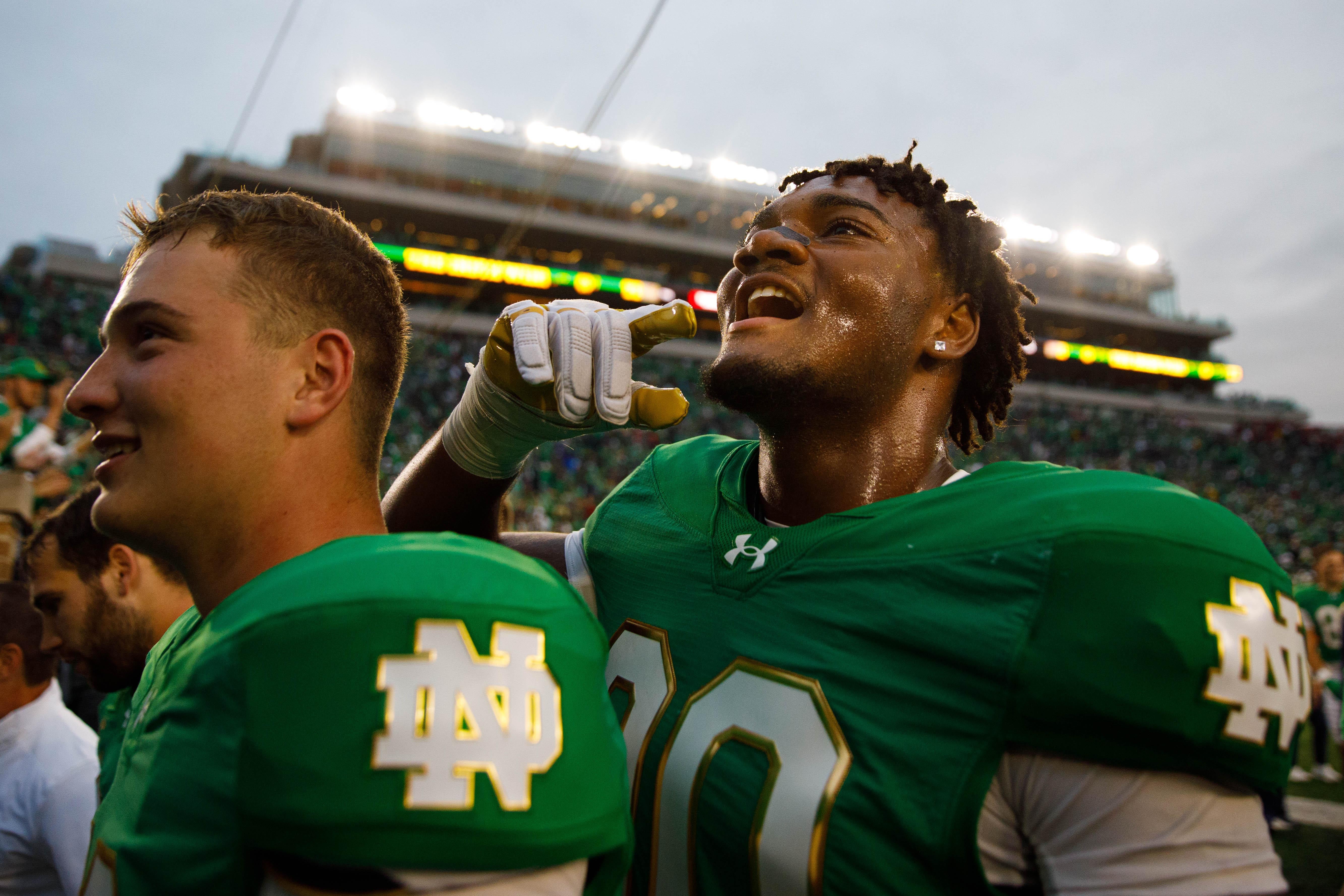 Notre Dame defensive lineman Bryce Young, right, celebrates after winning a NCAA college football game 31-24 between Notre Dame and Louisville at Notre Dame Stadium.