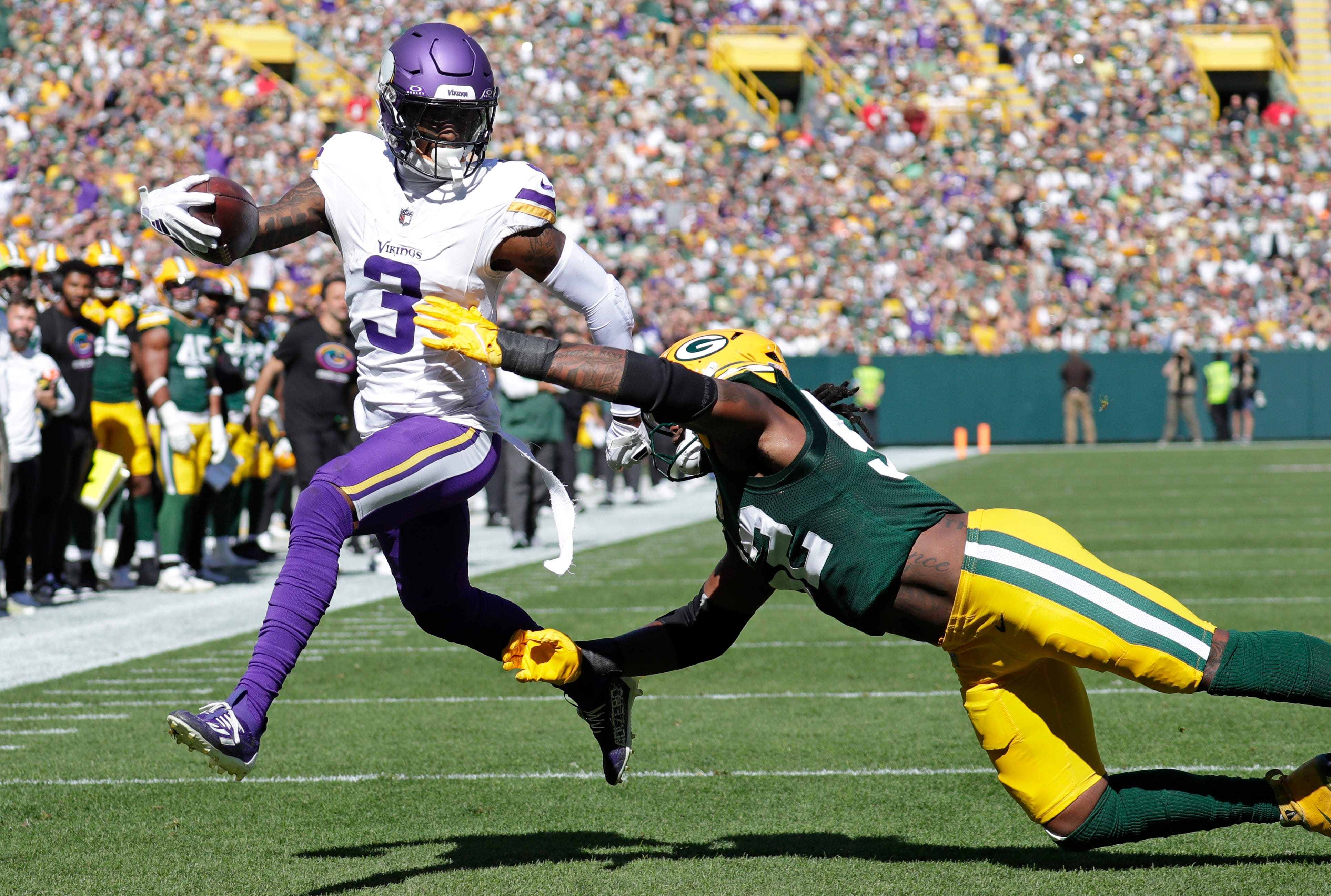 Minnesota Vikings wide receiver Jordan Addison (3) scores a touchdown run against Green Bay Packers defensive end Rashan Gary (52) in the second quarter during their football game Sunday, September 29, 2024, at Lambeau Field in Green Bay, Wisconsin.