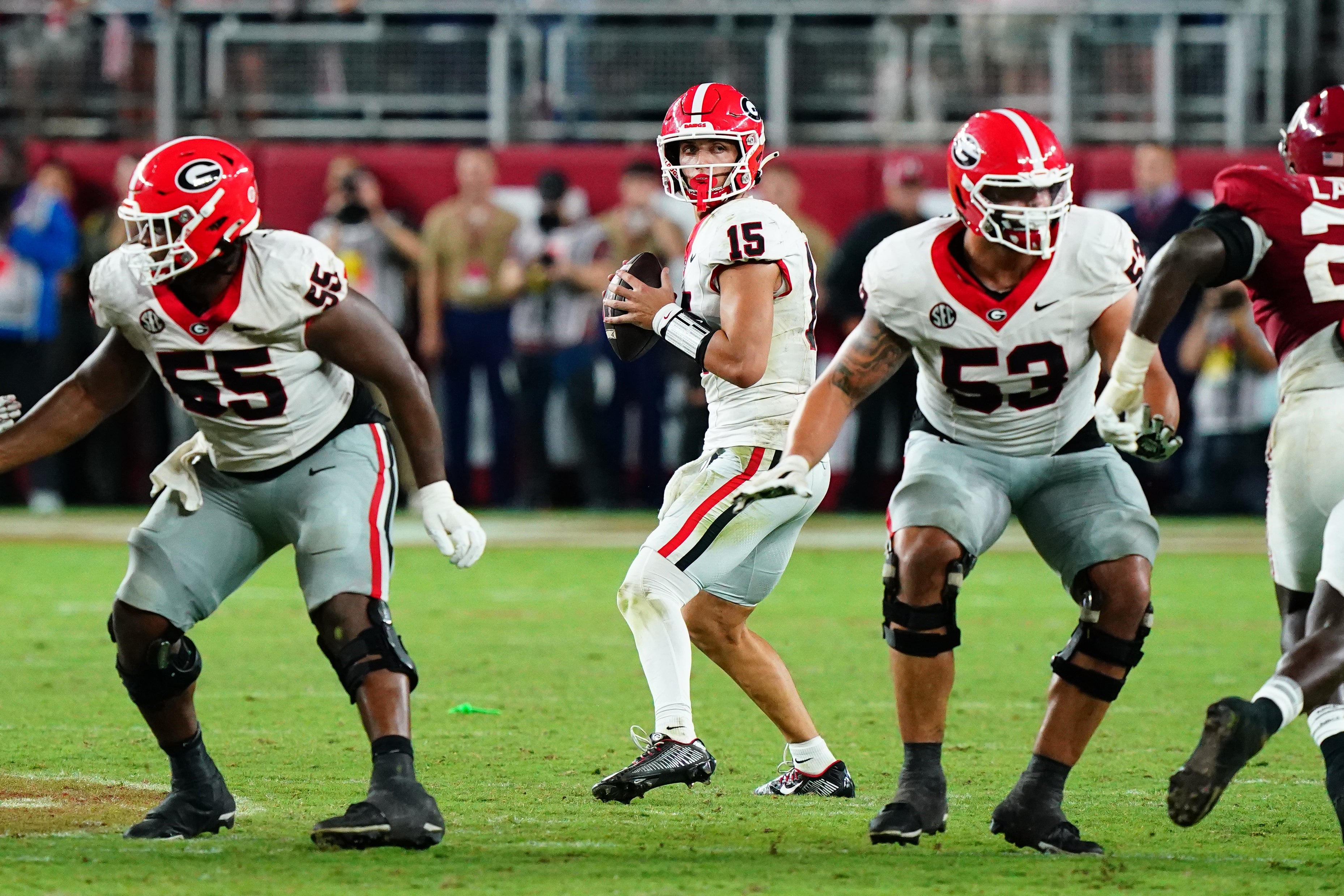 Georgia Bulldogs quarterback Carson Beck (15) drops back to throw against the Alabama Crimson Tide during the fourth quarter at Bryant-Denny Stadium.