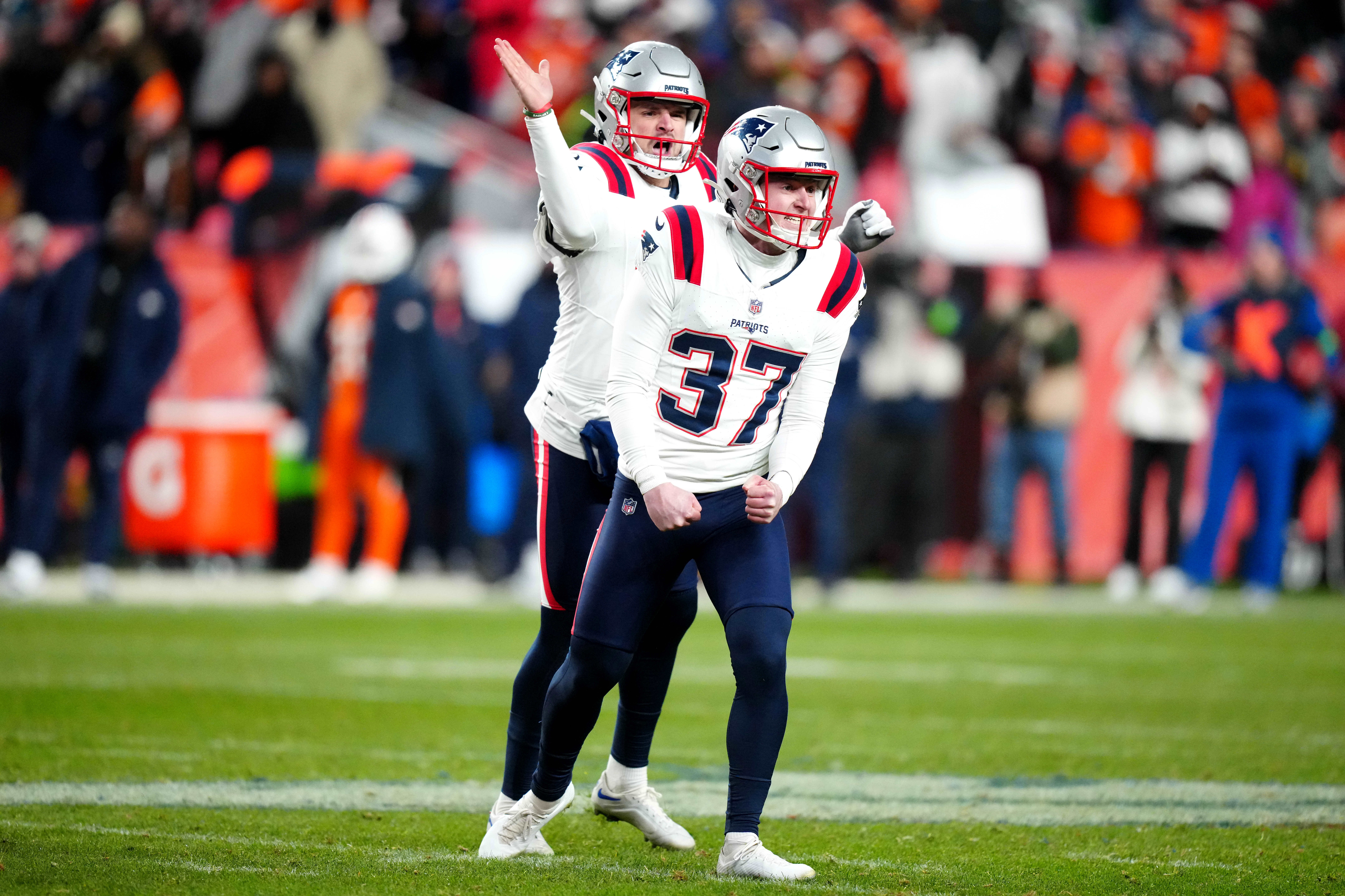 New England Patriots place kicker Chad Ryland (37) and long snapper Joe Cardona (49) celebrate the Denver Broncos at Empower Field at Mile High.