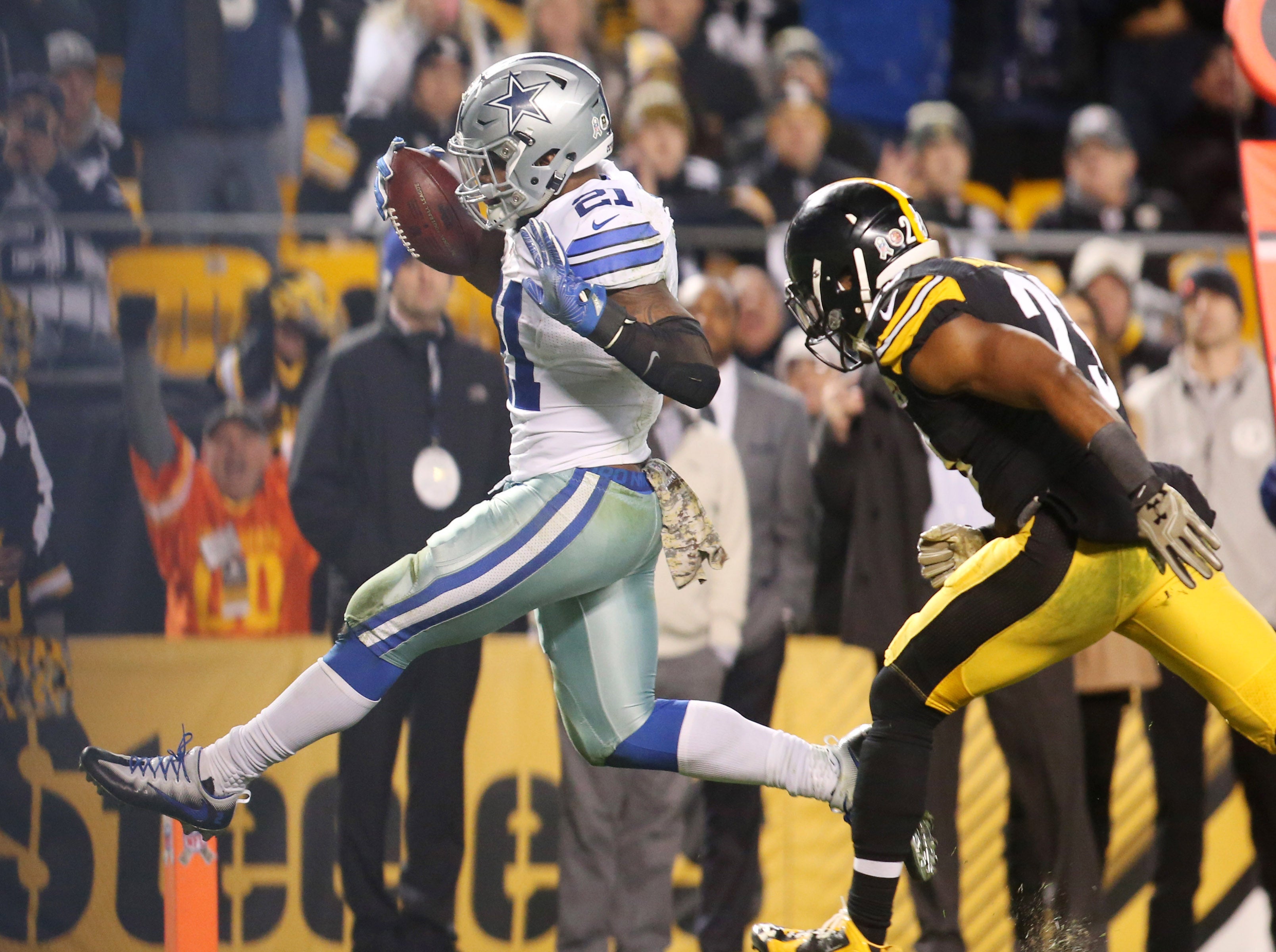 Dallas Cowboys running back Ezekiel Elliott (21) scores on a fourteen yard touchdown run past Pittsburgh Steelers free safety Mike Mitchell (23) during the fourth quarter at Heinz Field. Dallas won 35-30.